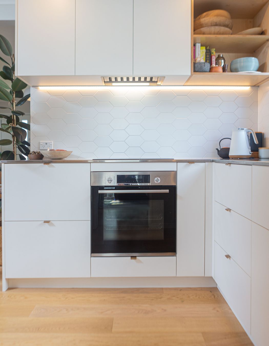 Steamlined cabinetry with ample storage. Induction hob and oven below.