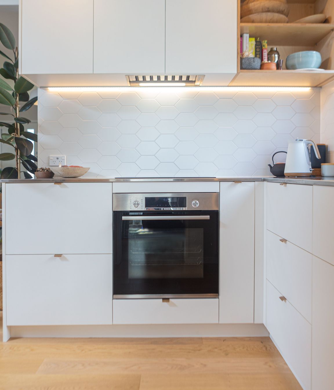 Steamlined cabinetry with ample storage. Induction hob and oven below.