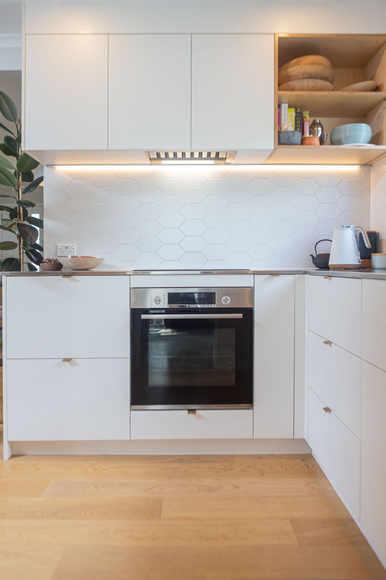 Steamlined cabinetry with ample storage. Induction hob and oven below.