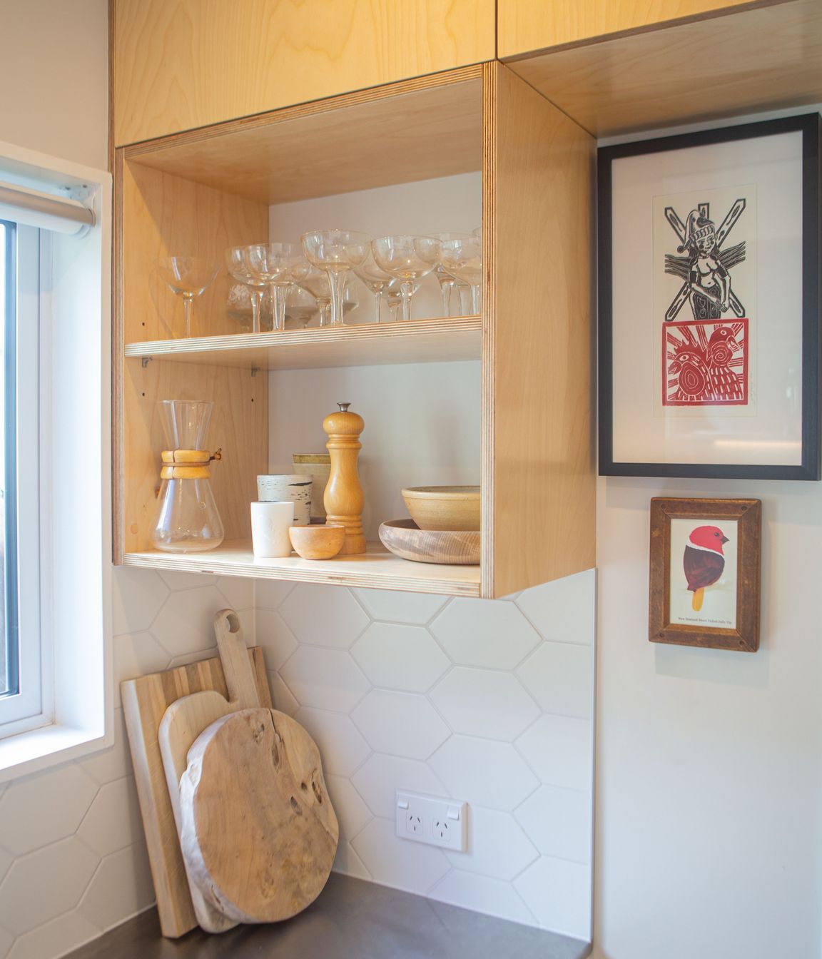 Open birch plywood shelving made use of the spaces around the window frame.