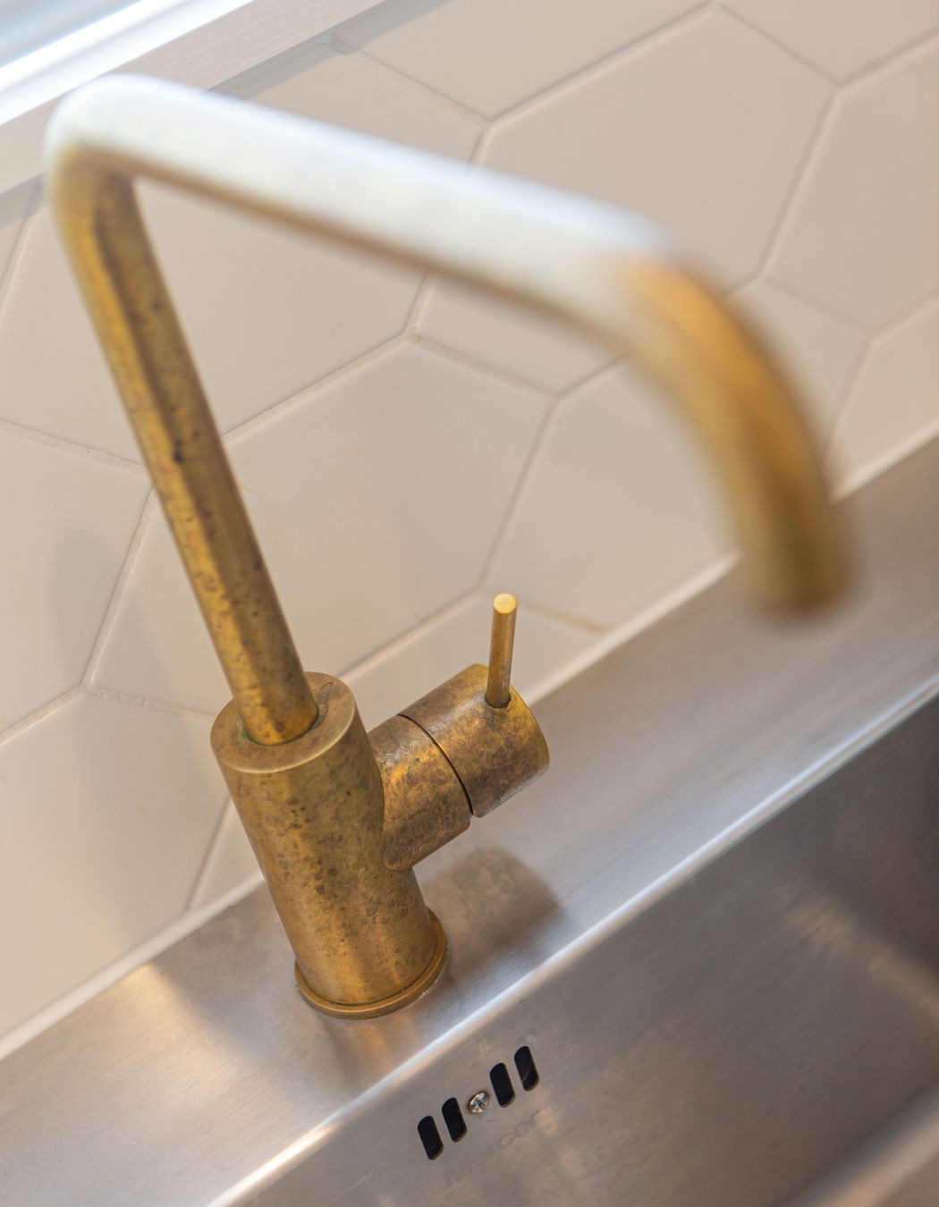 Brushed brass gooseneck tapware, has worn a beautiful patina with age.