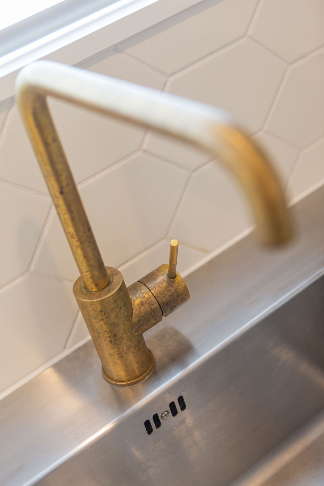 Brushed brass gooseneck tapware, has worn a beautiful patina with age.