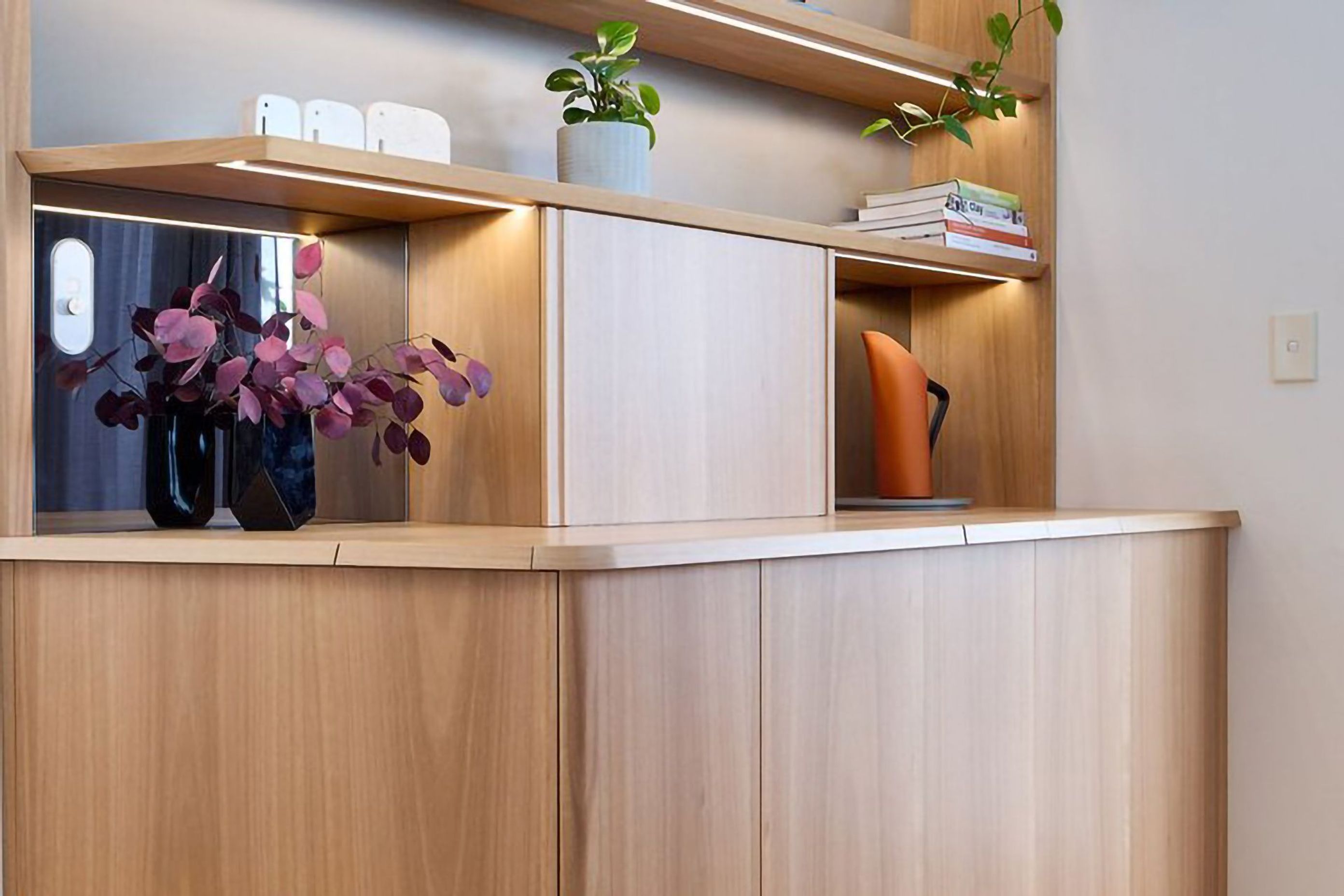 Vance's new display case uses the same material pallet of Blackbutt timber and grey FORESCOLOUR MDF as his kitchen to tie the spaces together.