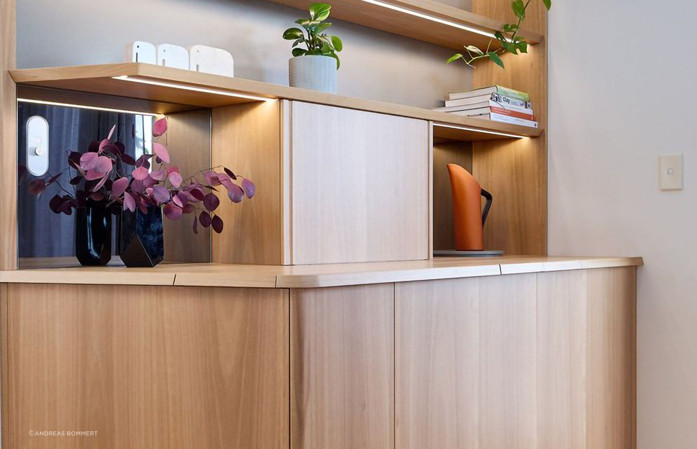 Vance's new display case uses the same material pallet of Blackbutt timber and grey FORESCOLOUR MDF as his kitchen to tie the spaces together.