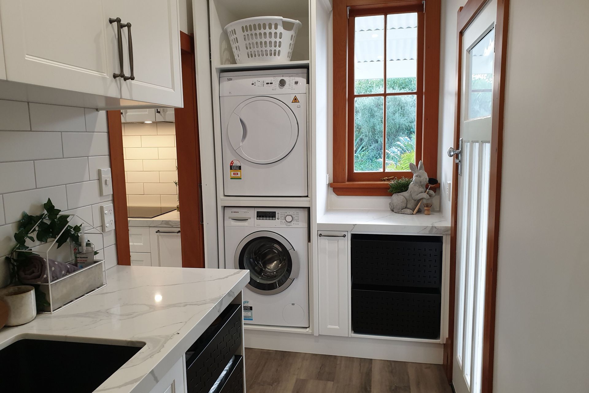 Salice Pocket Door Used to Create an Efficient Laundry Appliance Cupboard - Seen Here with Door Open