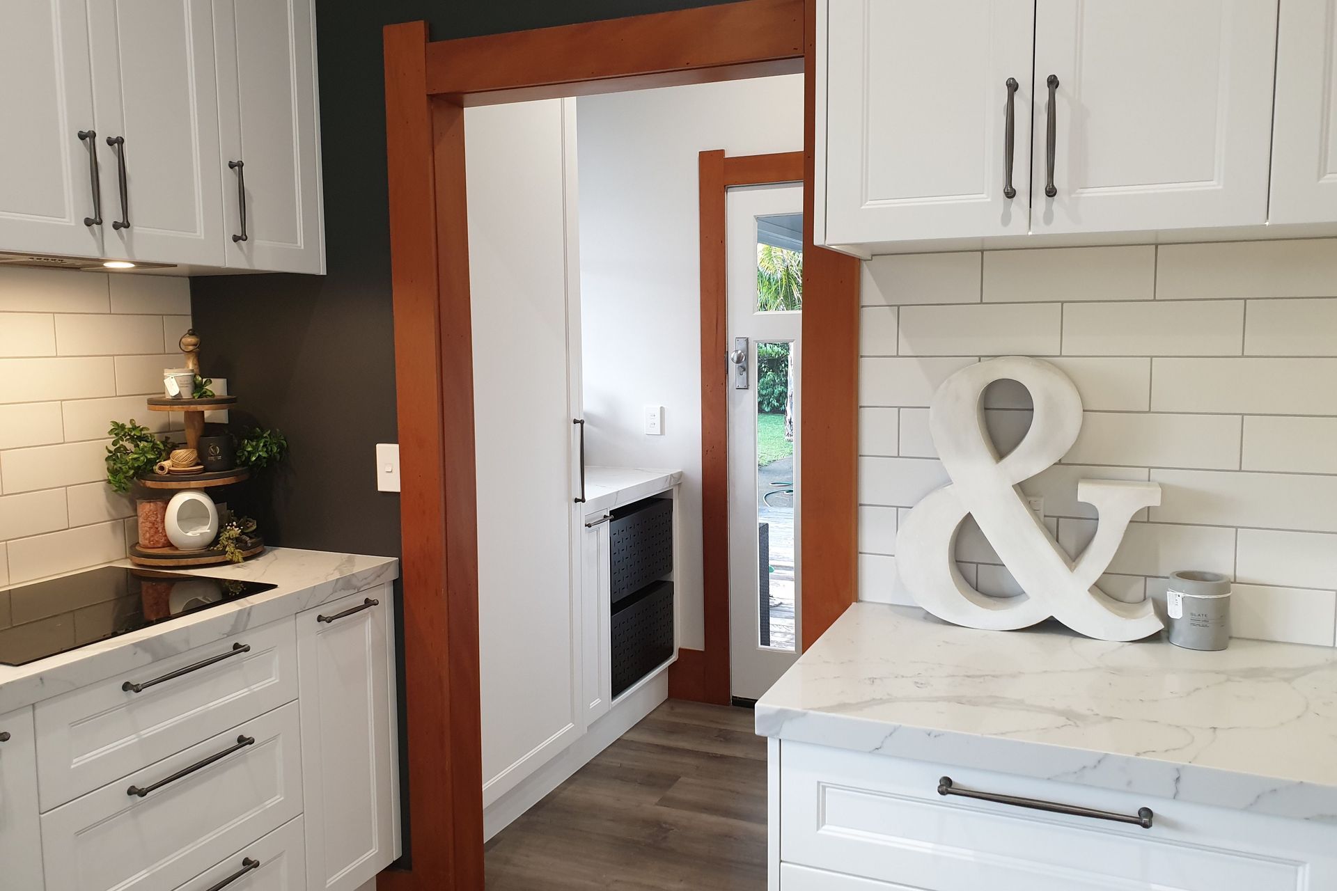Salice Pocket Door Used to Create an Efficient Laundry Appliance Cupboard - Seen Here with Door Closed (Open in Next Photo)