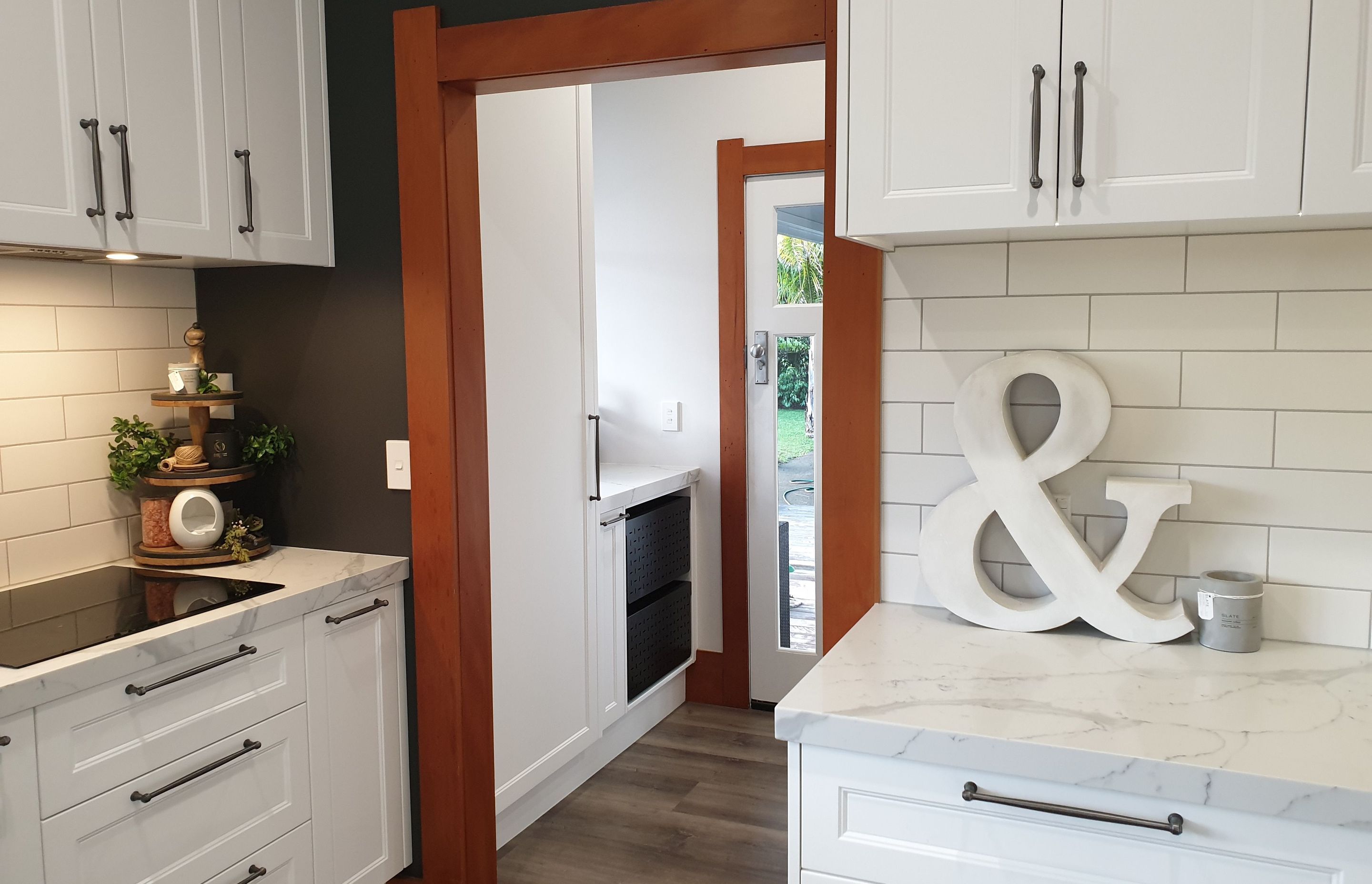 Salice Pocket Door Used to Create an Efficient Laundry Appliance Cupboard - Seen Here with Door Closed (Open in Next Photo)