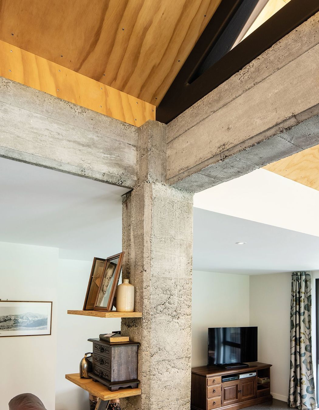The owners wanted to embrace the historic context of the building, so the concrete frame of the shed has been exposed on the interior of the new home.
