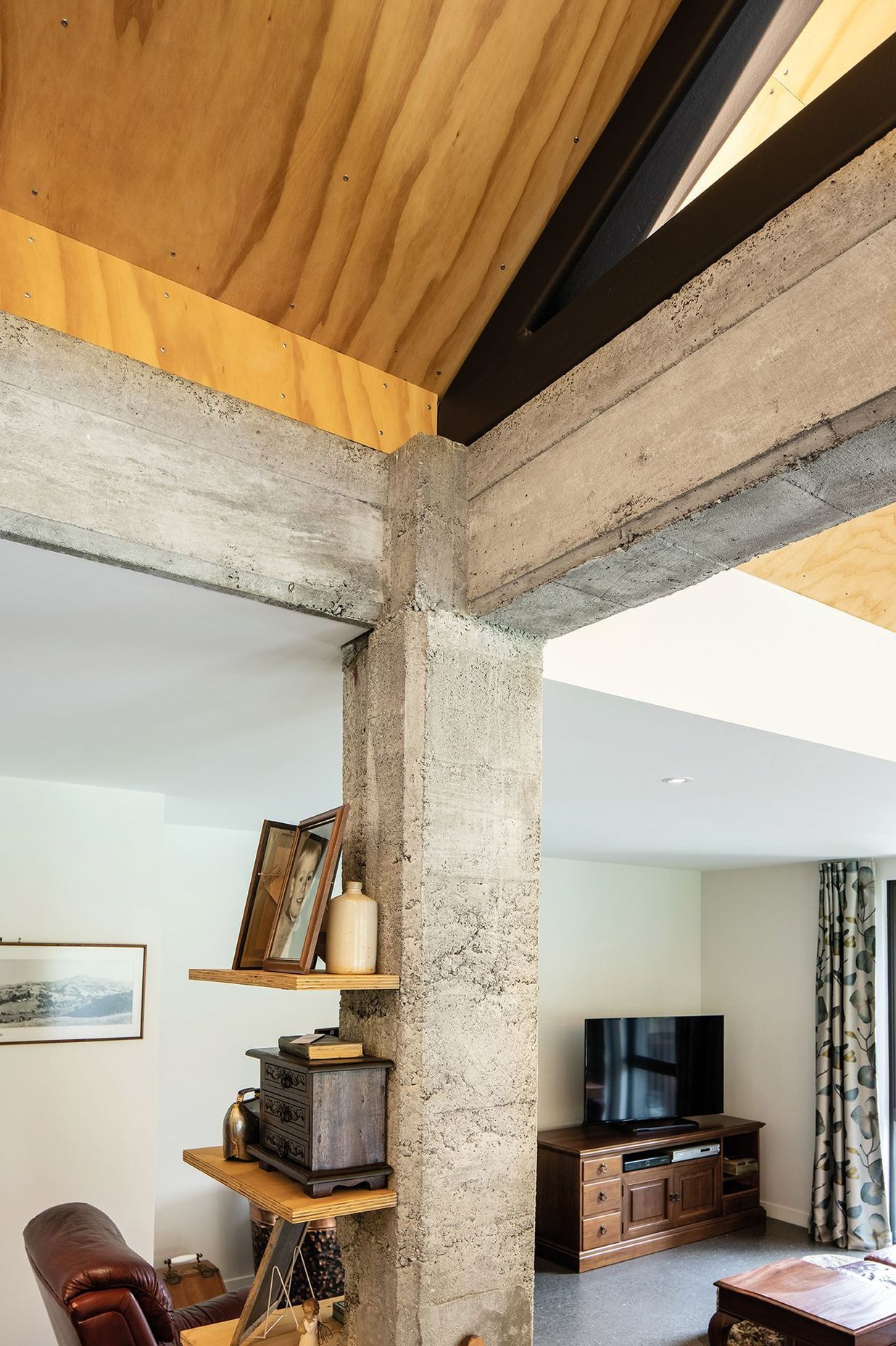 The owners wanted to embrace the historic context of the building, so the concrete frame of the shed has been exposed on the interior of the new home.