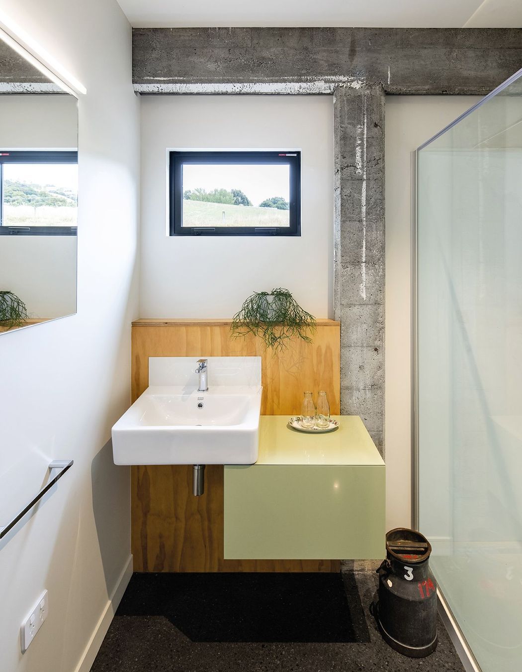 While the concrete frame has been cleaned and patched it still bears the marks of age, contrasting with the new elements, such as in this bathroom.