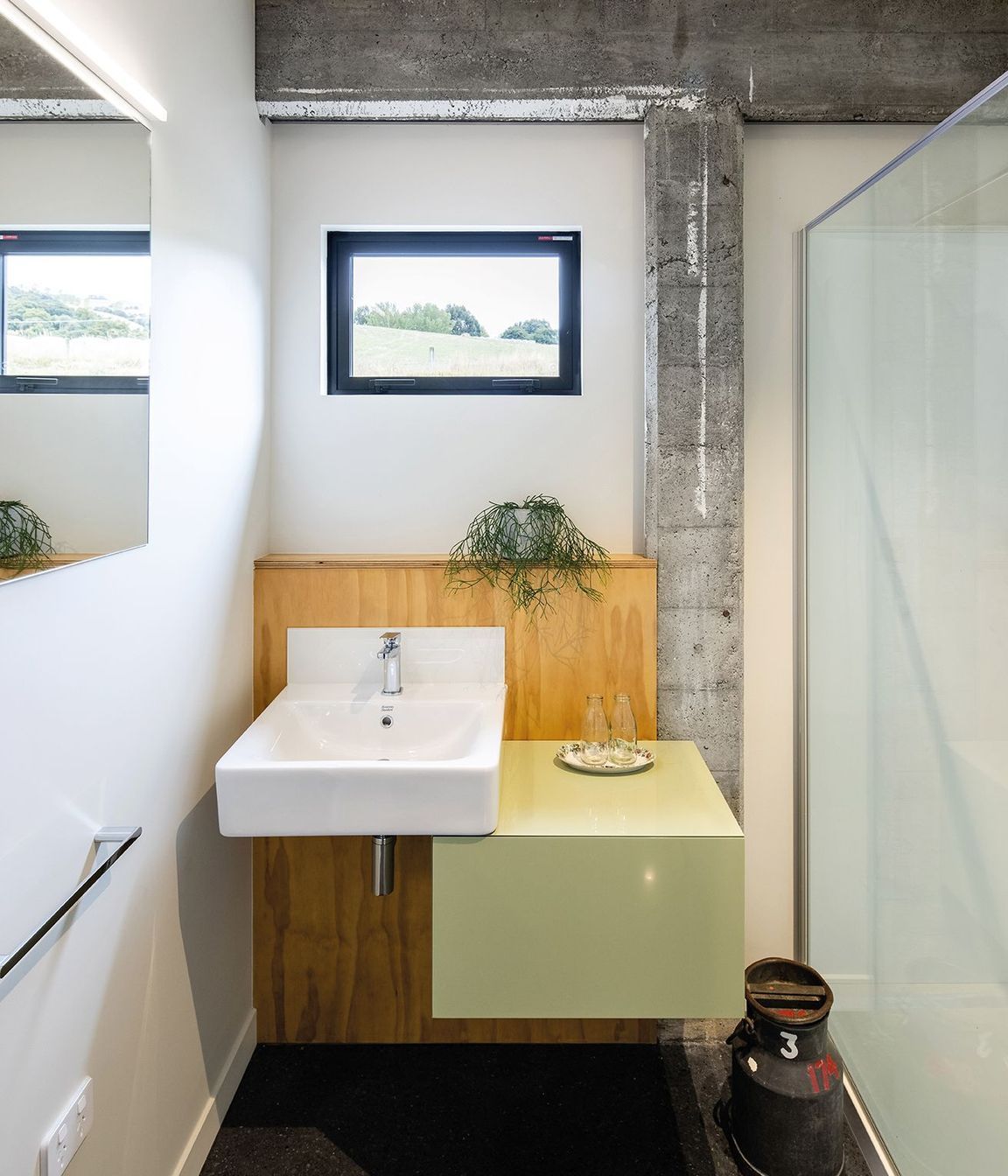 While the concrete frame has been cleaned and patched it still bears the marks of age, contrasting with the new elements, such as in this bathroom.