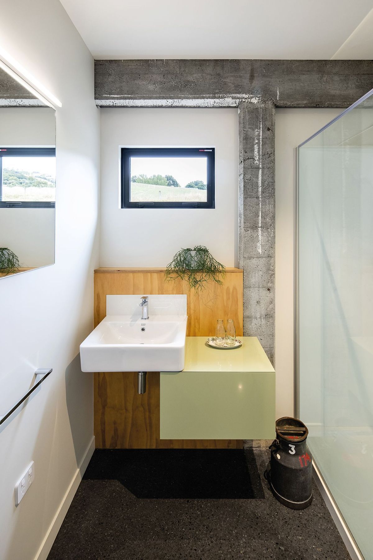 While the concrete frame has been cleaned and patched it still bears the marks of age, contrasting with the new elements, such as in this bathroom.