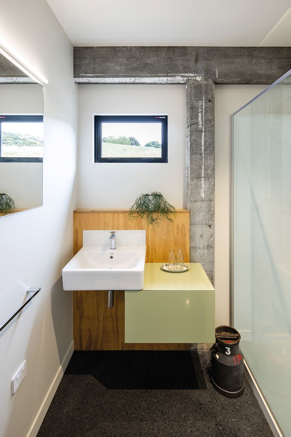 While the concrete frame has been cleaned and patched it still bears the marks of age, contrasting with the new elements, such as in this bathroom.
