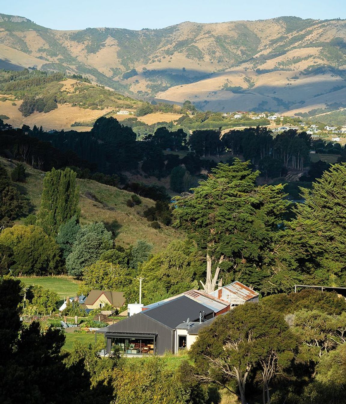 Nestled into Banks Peninsula, this three-bedroom family home was once a cow shed.