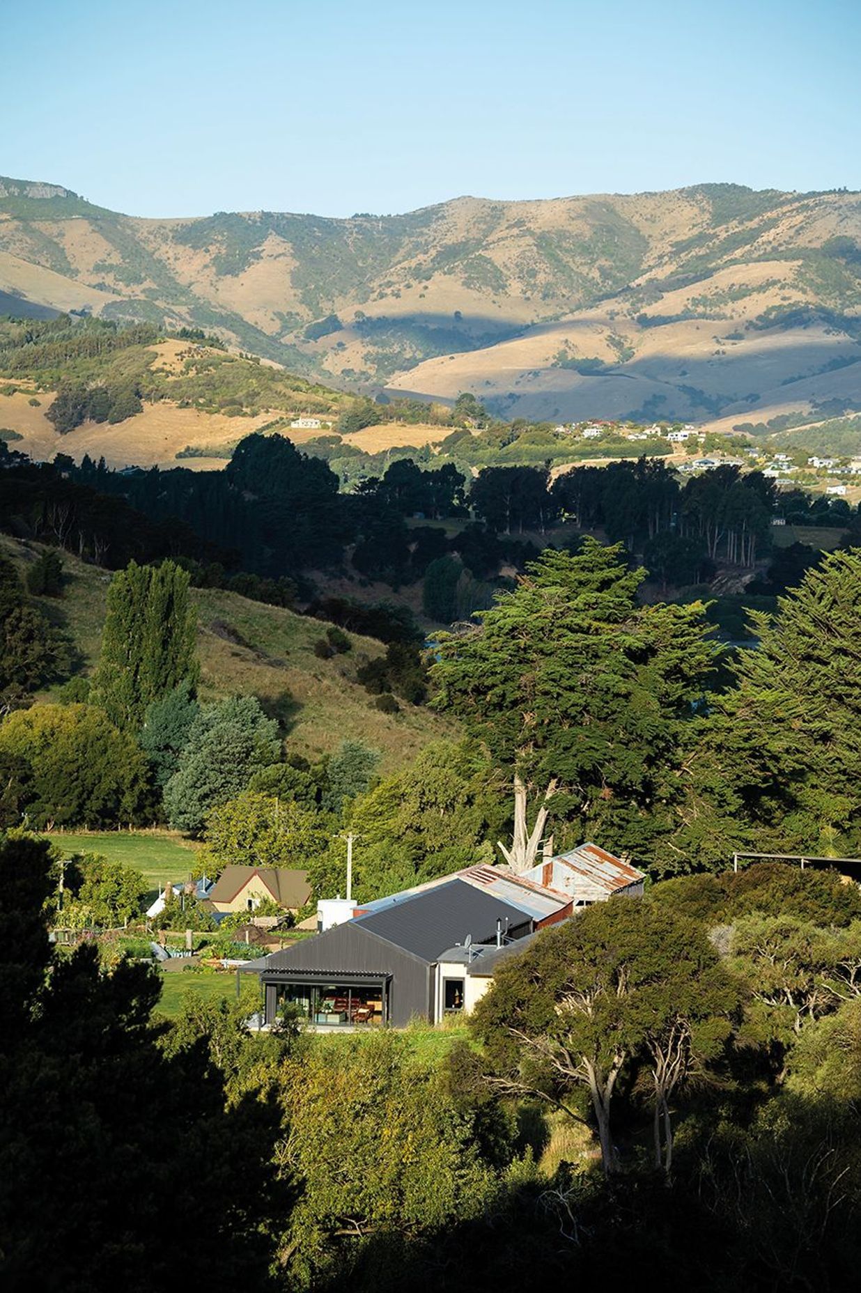 Nestled into Banks Peninsula, this three-bedroom family home was once a cow shed.