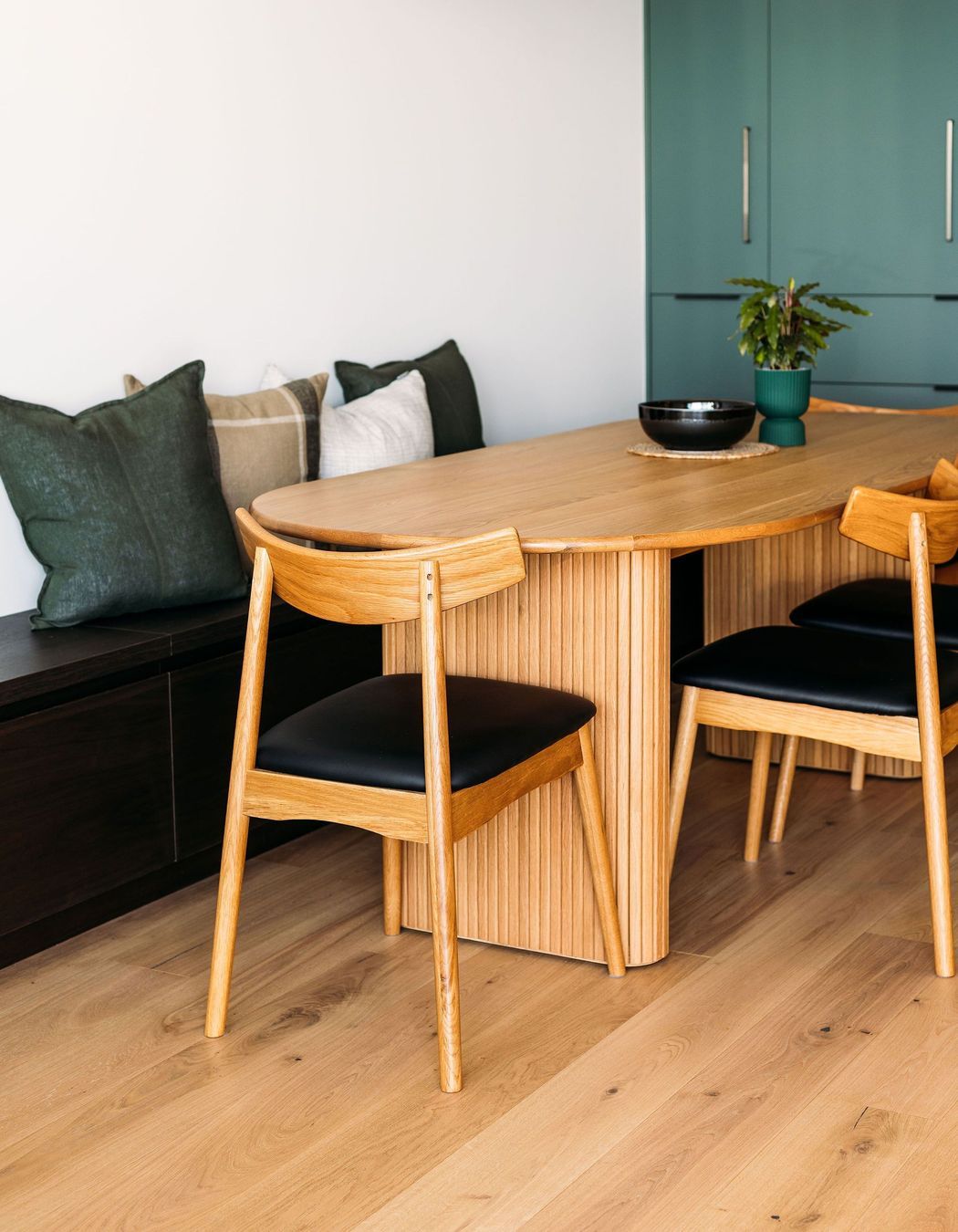 The dining table was chosen to allow it to be pushed right against the wall and allow more space when needed.