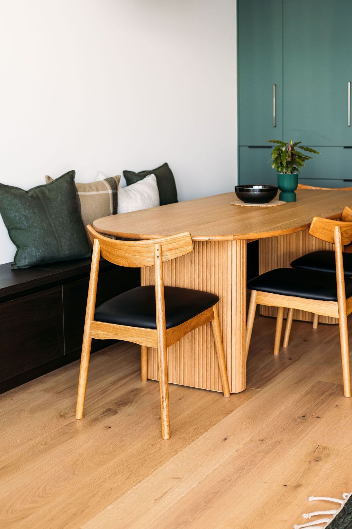 The dining table was chosen to allow it to be pushed right against the wall and allow more space when needed.
