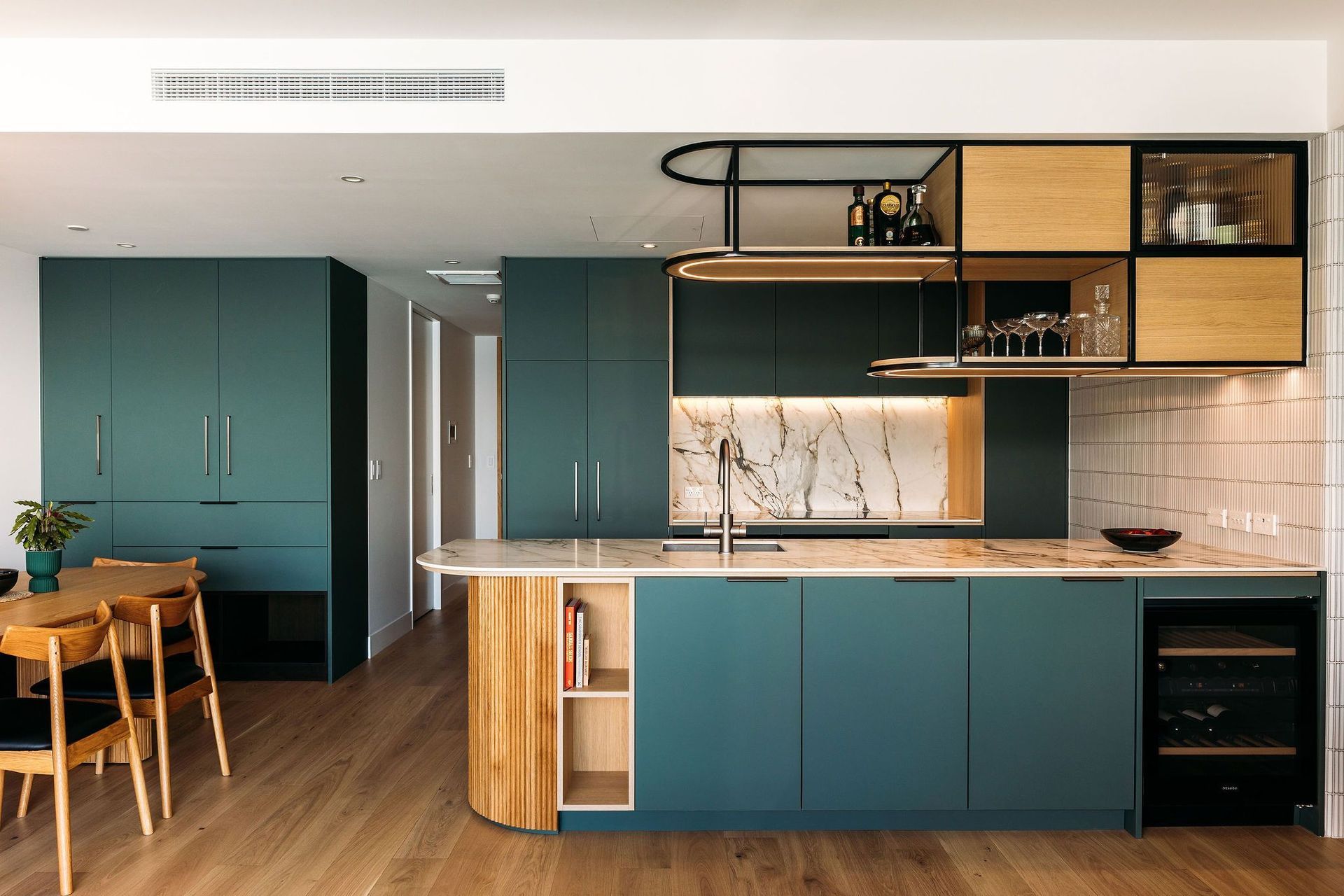 Reflecting the changing hues of the sea, this kitchen sits proud in the waterfront apartment.