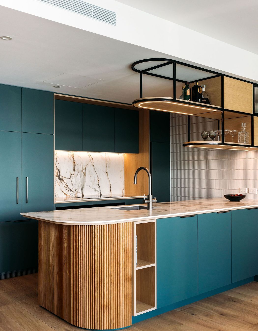 The raduised bench top is reflected in the fluted battens below.