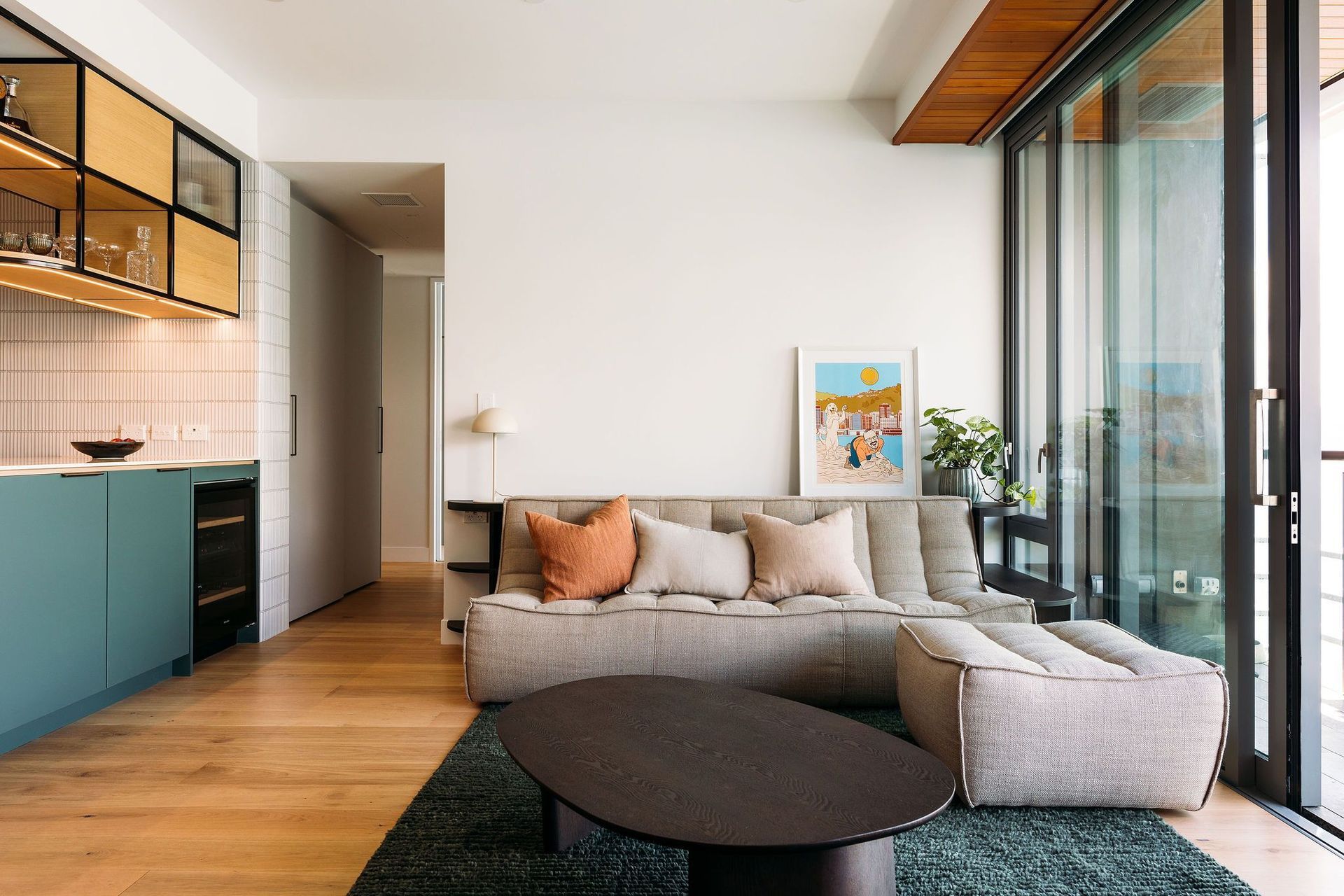 Custom cabinetry hugs the comfortable sofa - a place to set down your wine glass while watching the view.