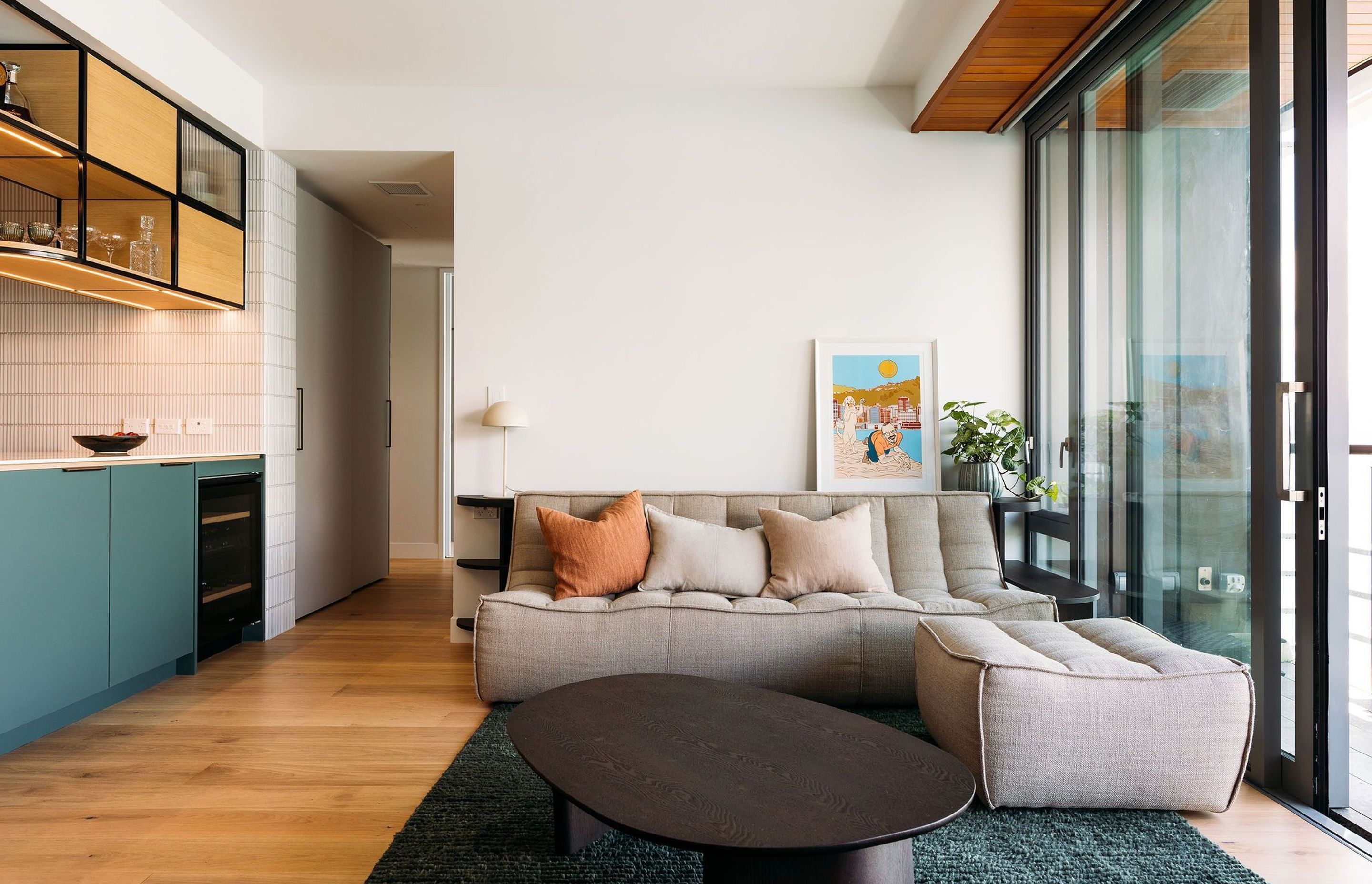 Custom cabinetry hugs the comfortable sofa - a place to set down your wine glass while watching the view.