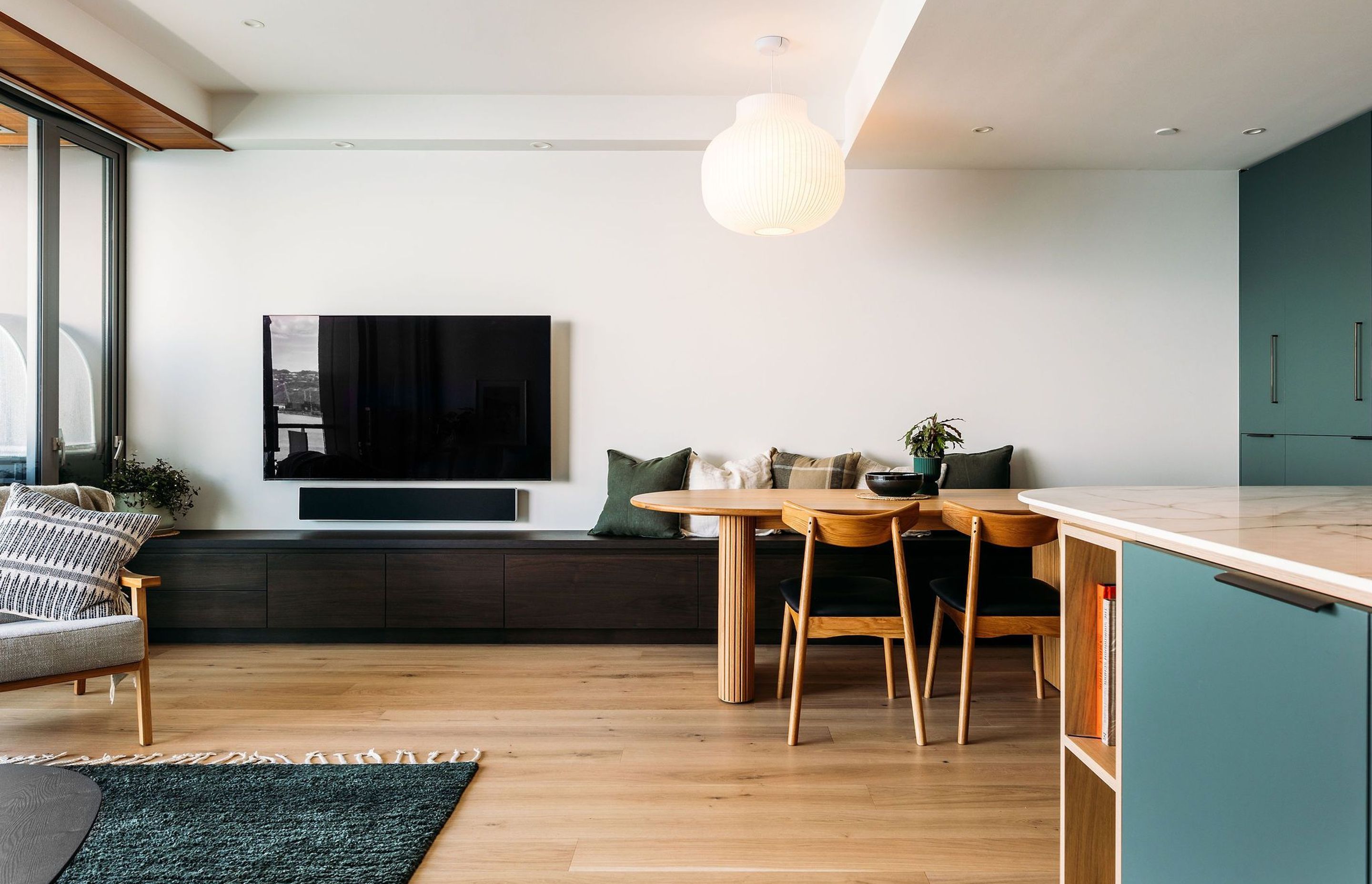 The bench seat cabinetry houses drawers the full length of the room.