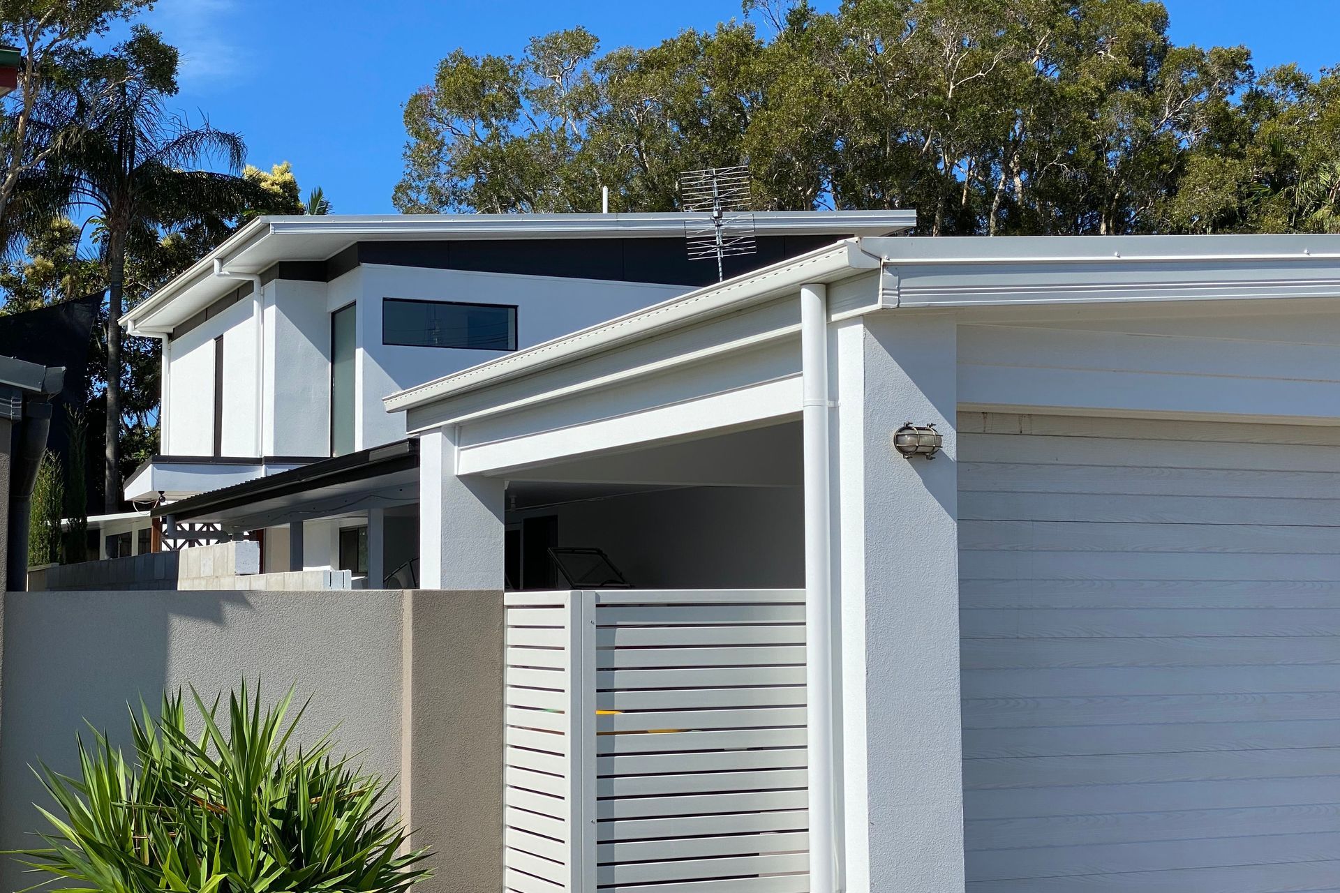 New 2 storey addition behind new carport and existing house