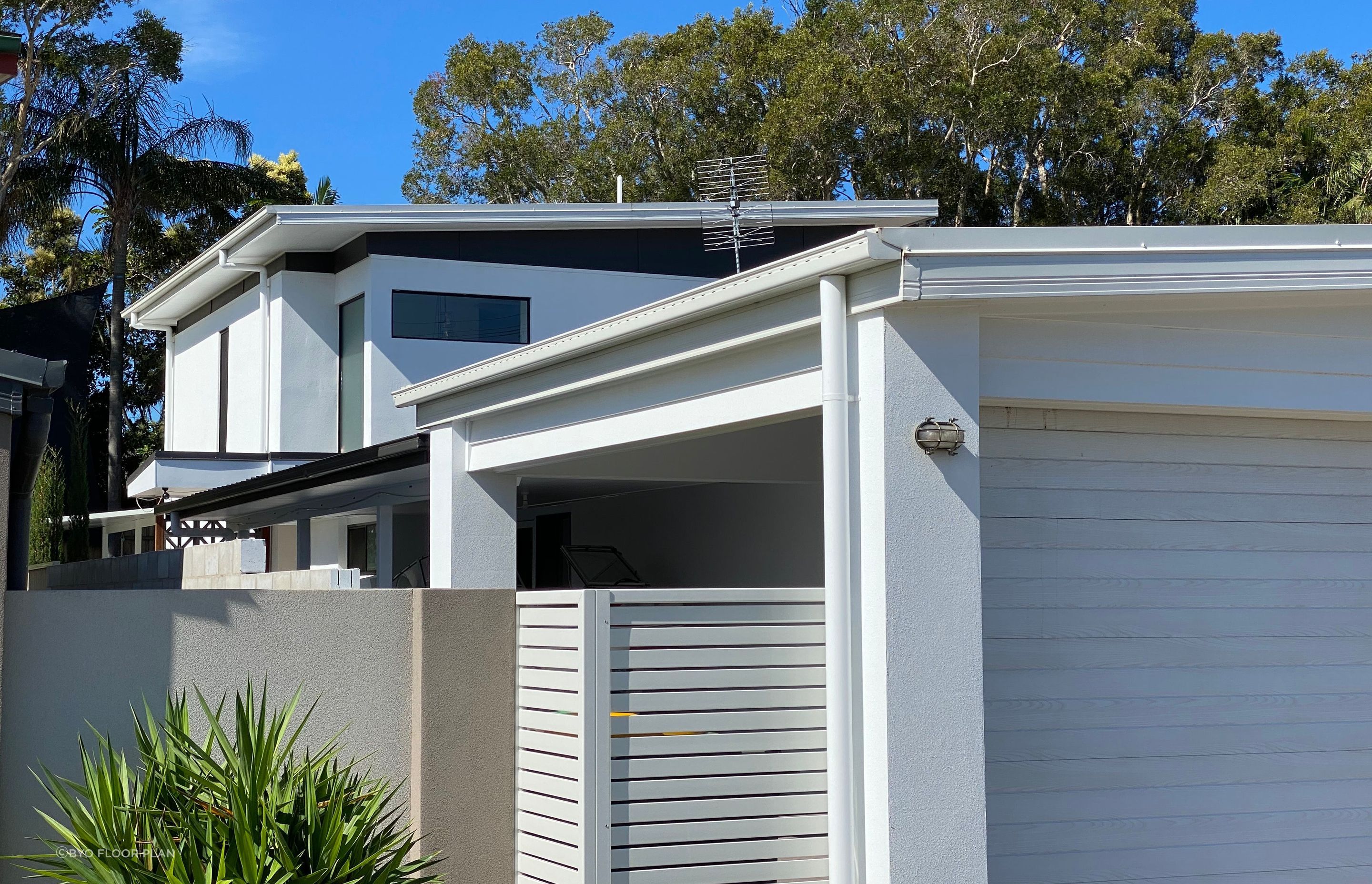 New 2 storey addition behind new carport and existing house