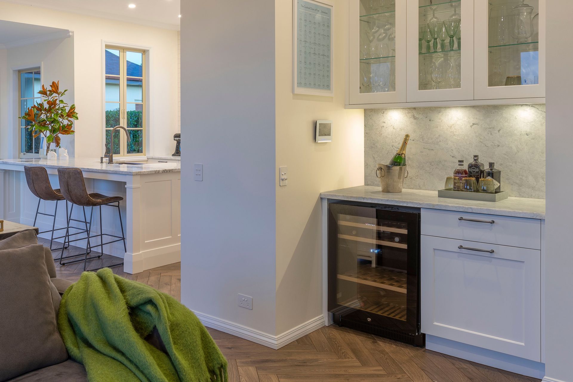 By shifting the Pool Room door for better logical flow from the entrance, a Drinks Bar could be incorporated. With plenty of dedicated storage for the entertaining owners' wine, spirits and glasses, guests can mingle and self-serve away from the busy kitchen space.