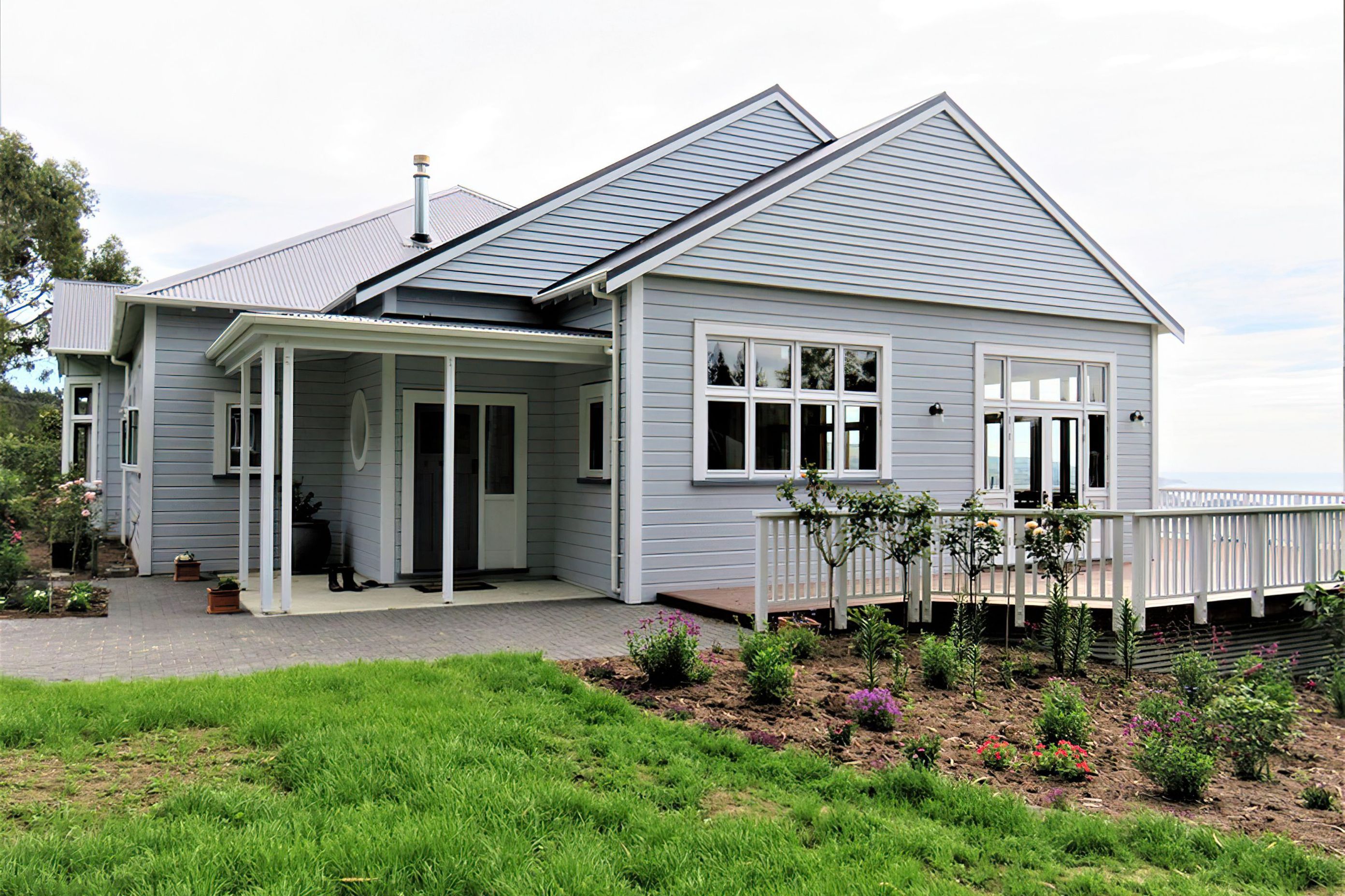 Wooden windows and kitchen joinery at this Blueskin Bay beach house by Ron Kirk joinery
