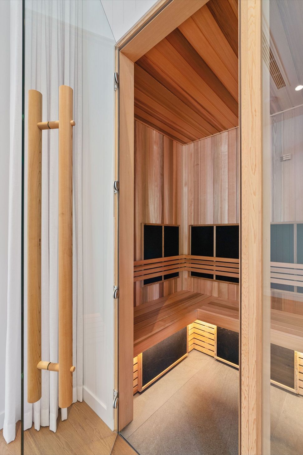 A cedar sauna adds a quiet wellness retreat within the home.