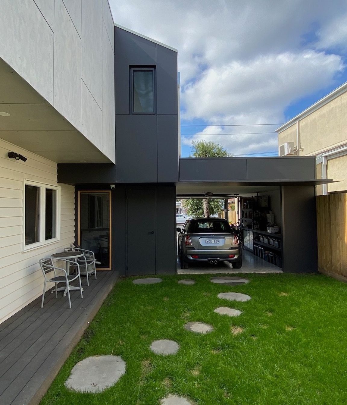 The garage provides privacy to the side garden and can be used as a space for entertaining