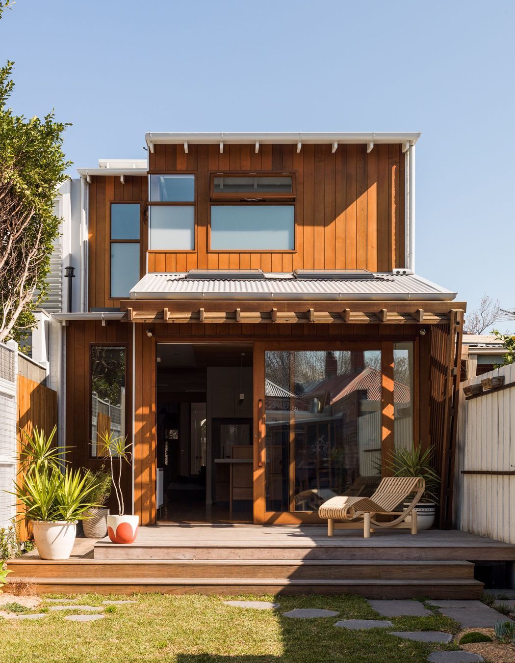 View of rear deck, and sliding doors leading into the kitchen.