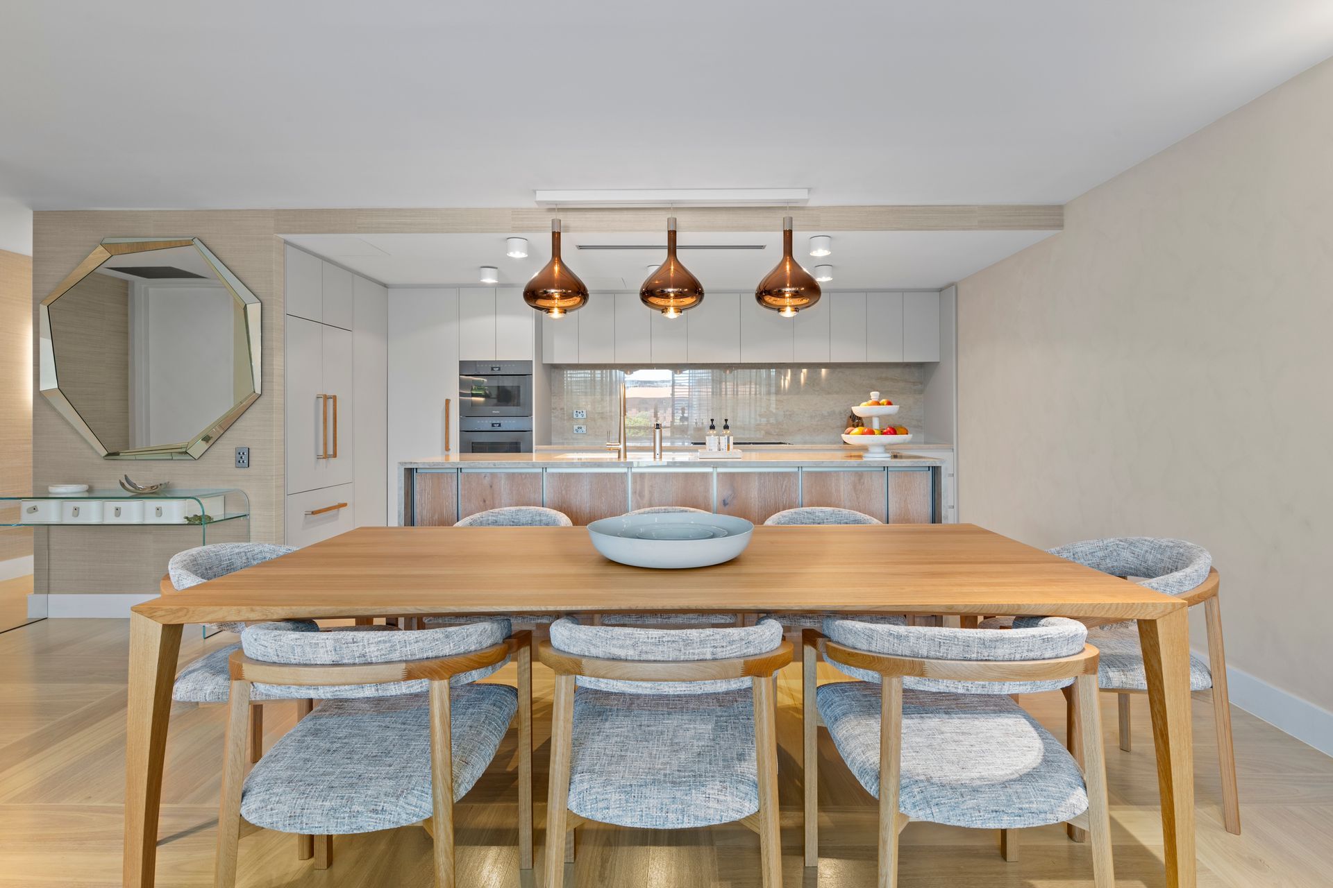 Designed dining furnishings and lighting with the new kitchen beyond.