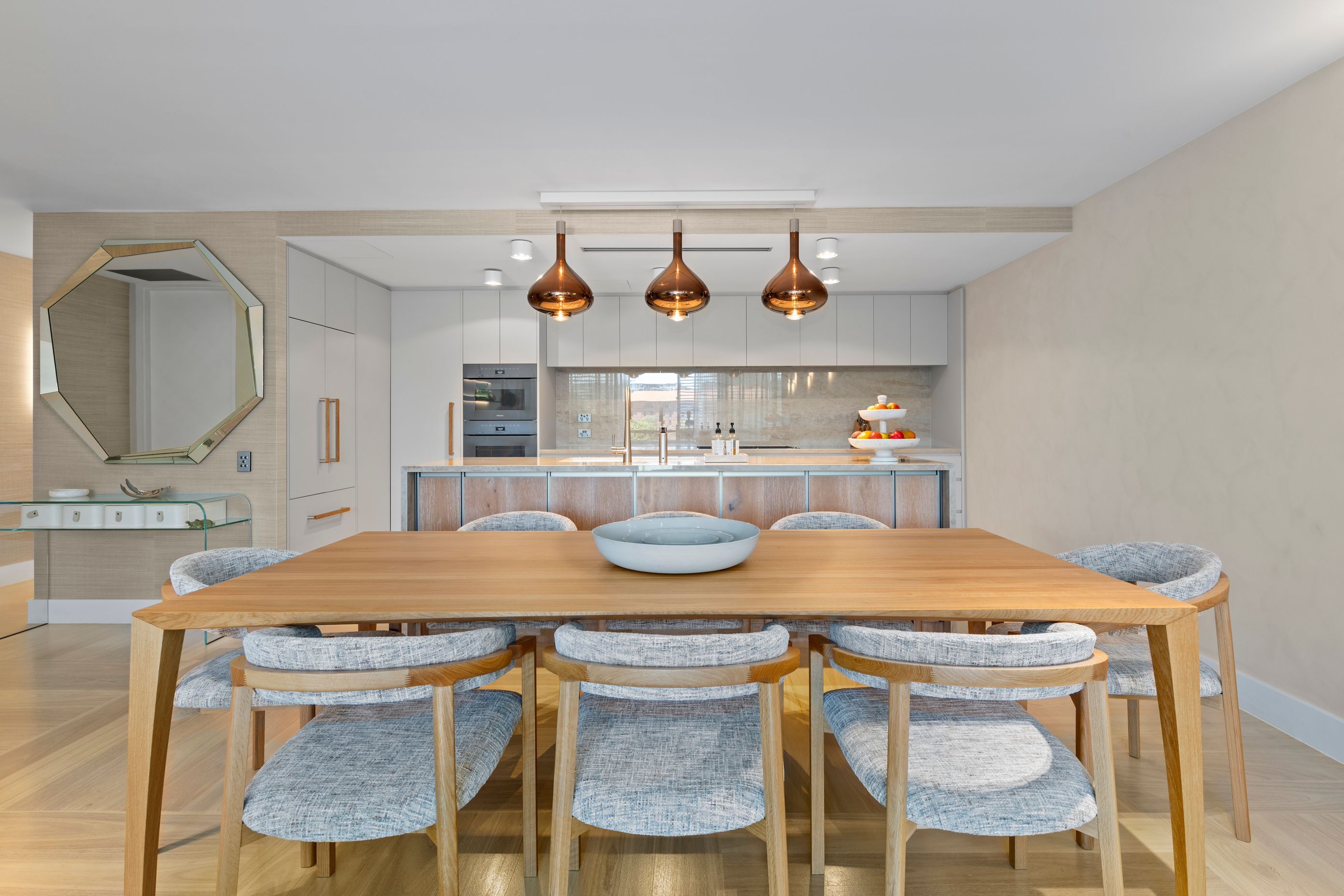 Designed dining furnishings and lighting with the new kitchen beyond.