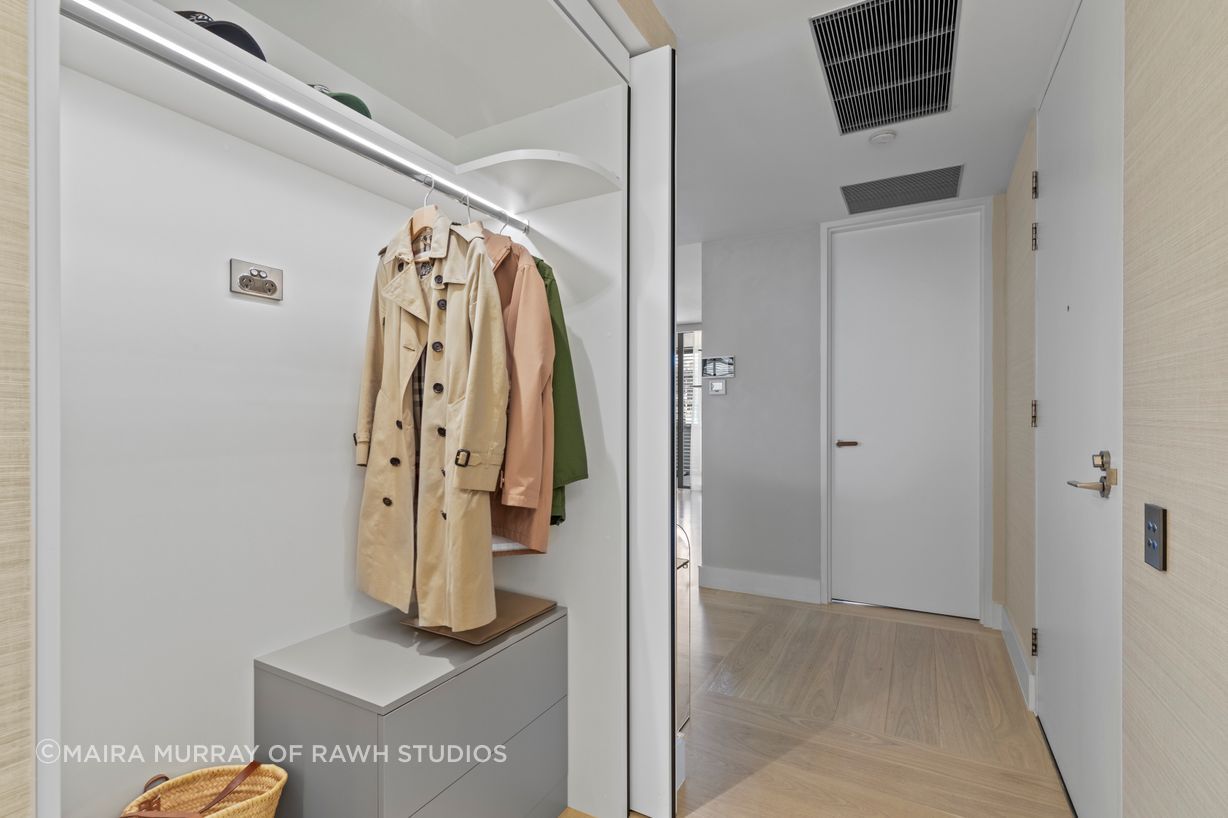 The interior of the walk-in robe showing Blum ‘Revego’ fold away doors created from an old air-conditioning cupboard.
