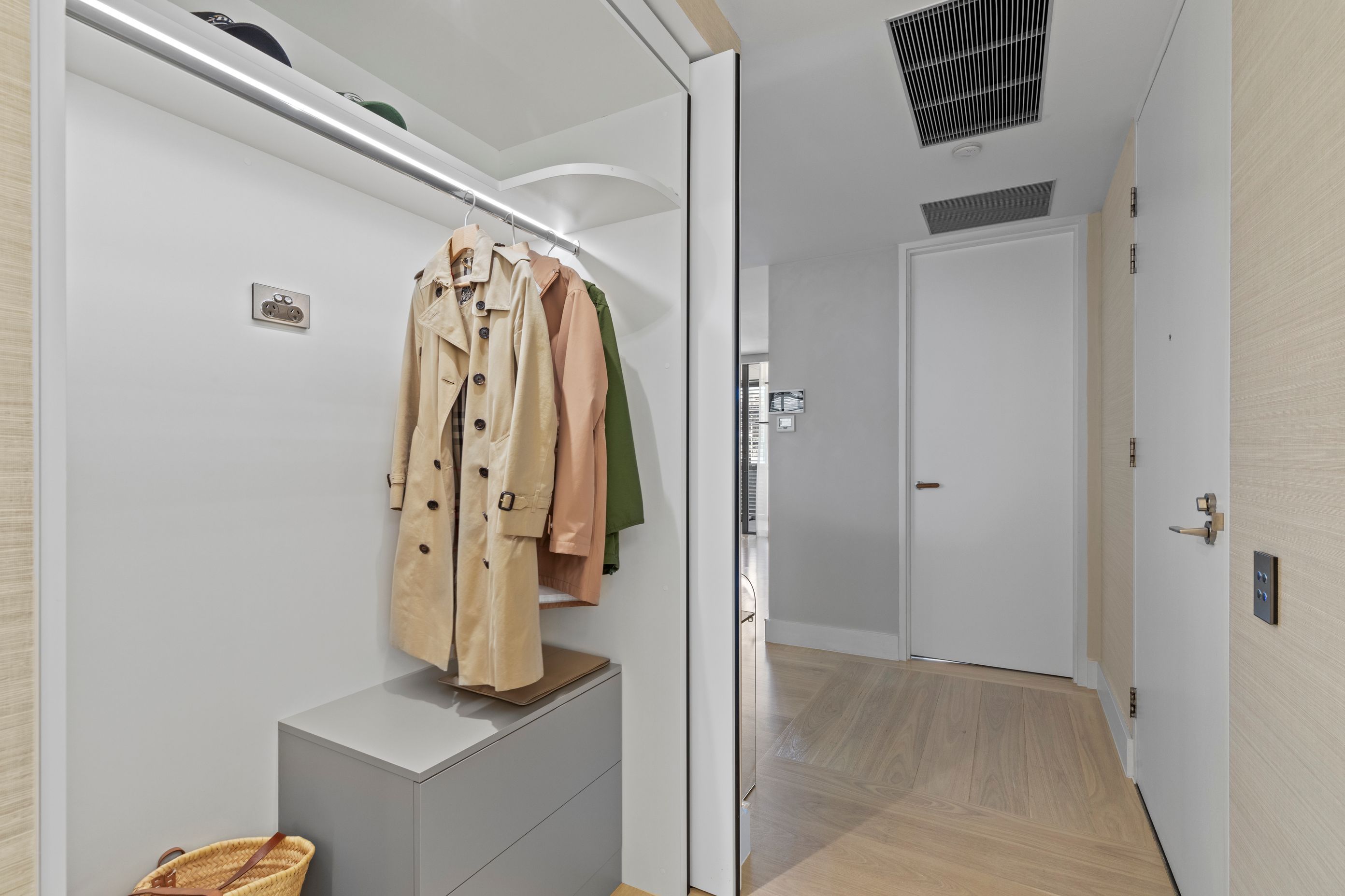 The interior of the walk-in robe showing Blum ‘Revego’ fold away doors created from an old air-conditioning cupboard.