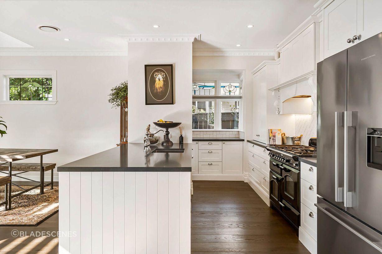The new kitchen features custom built cabinetry and high end appliances. It has a large scullery with a sink and plenty of storage tucked around the back, with windows looking out to the garden to bring in plenty of light.