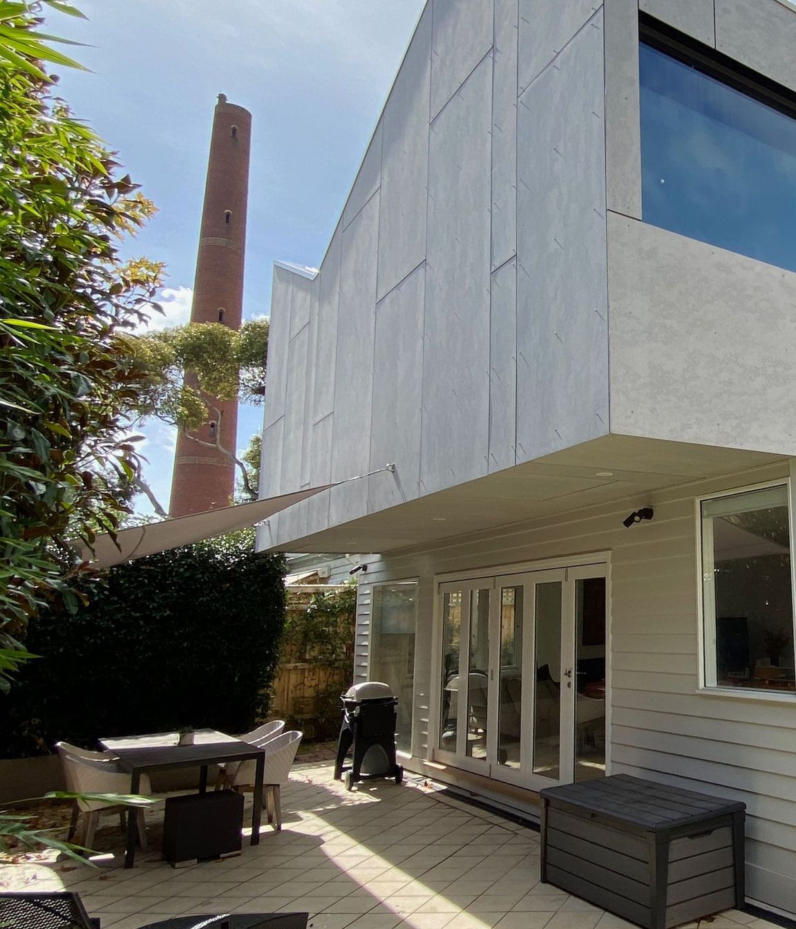 Upper storey extension is clad in unpainted fibre cement sheet