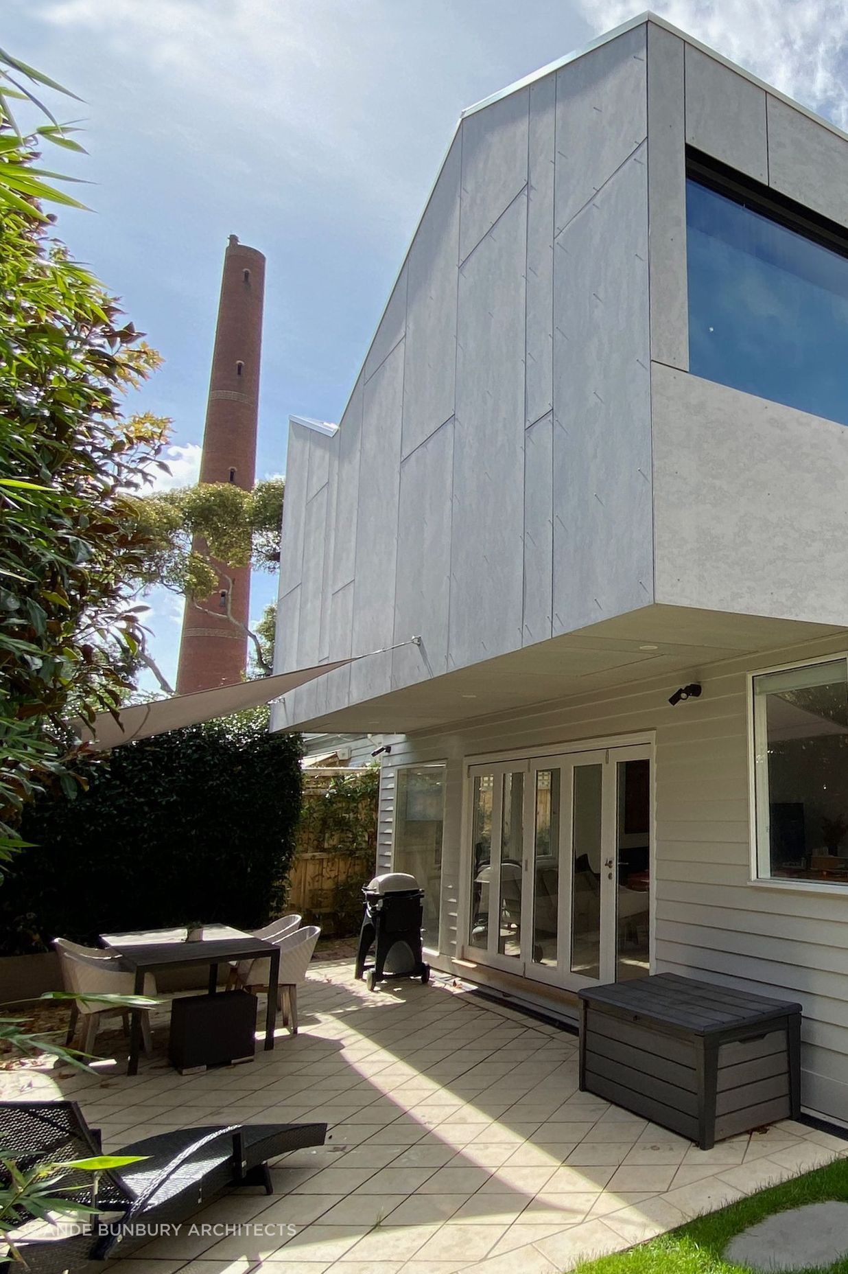 Upper storey extension is clad in unpainted fibre cement sheet