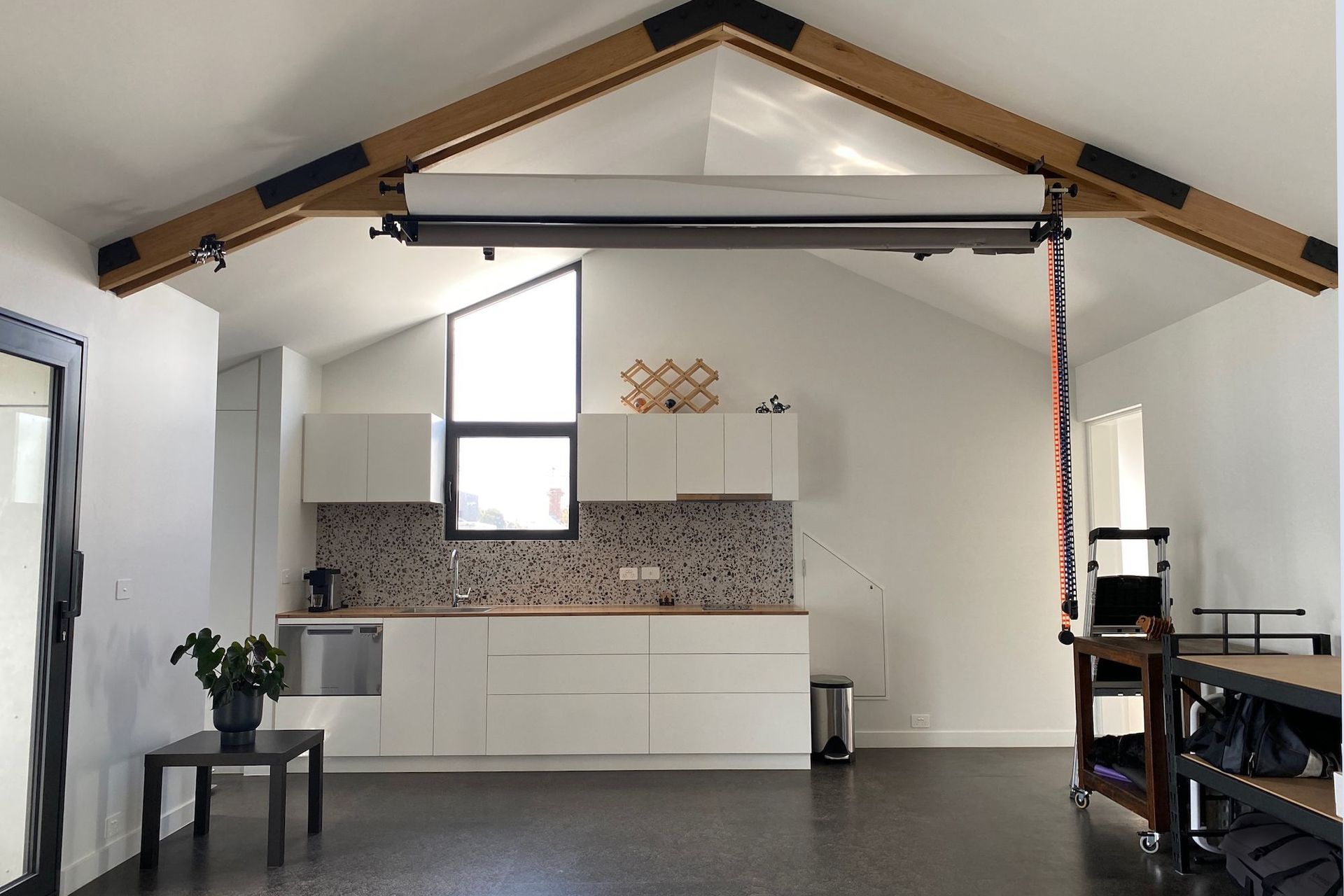 Exposed timber trusses provide mountings for photography equipment