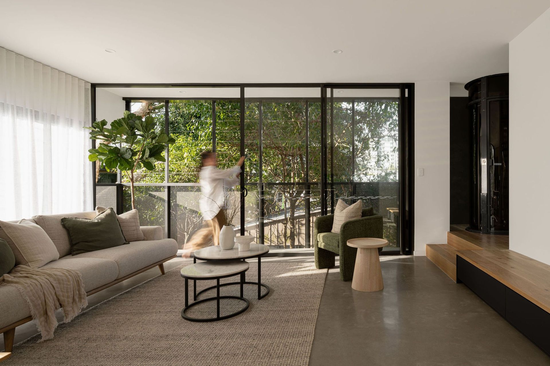 The Smith - Living Room. Living area opening to a leafy balcony.
