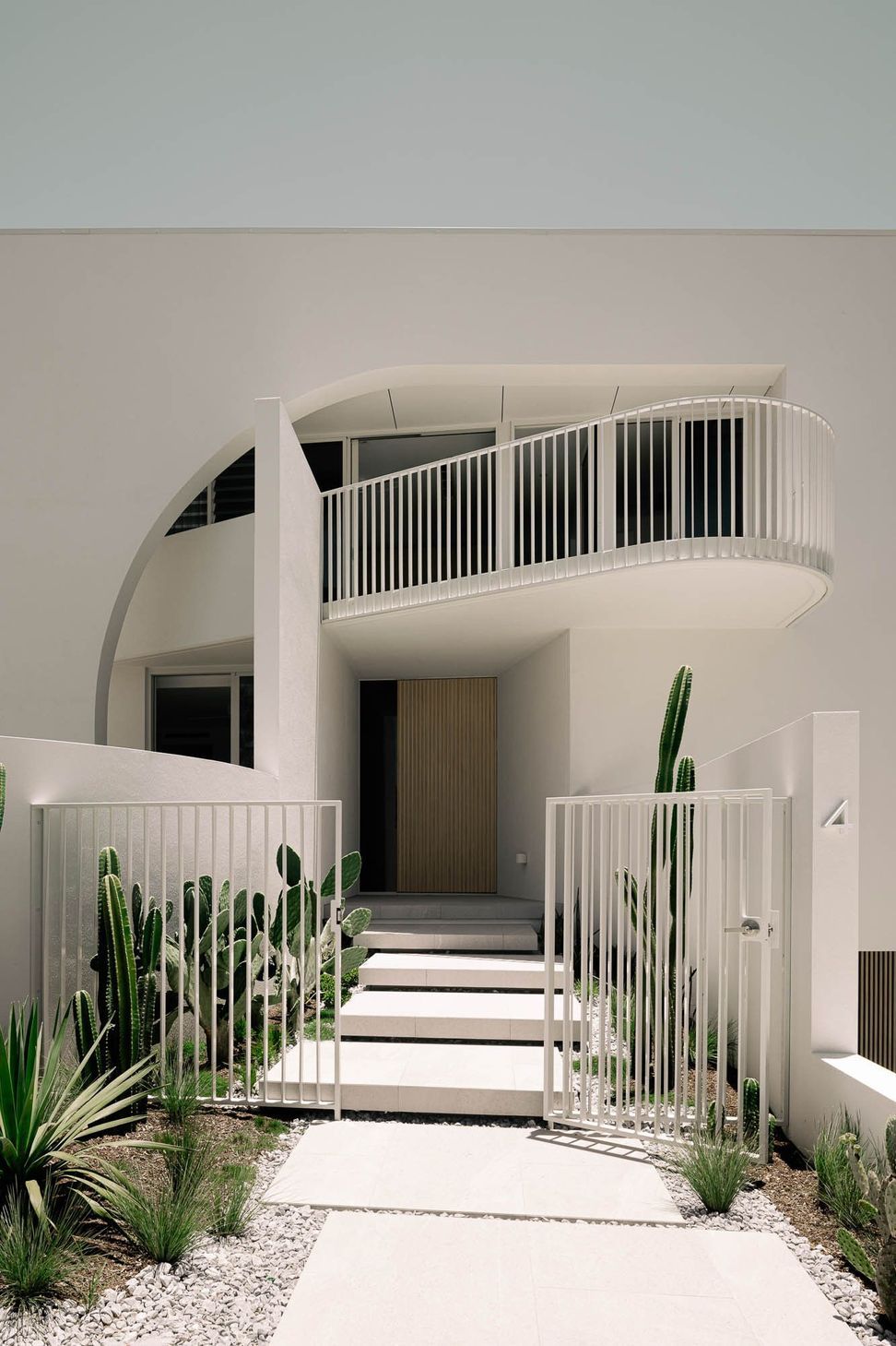 Zaremba Residence - Entry. Arched opening and stepping path leading to the front door.