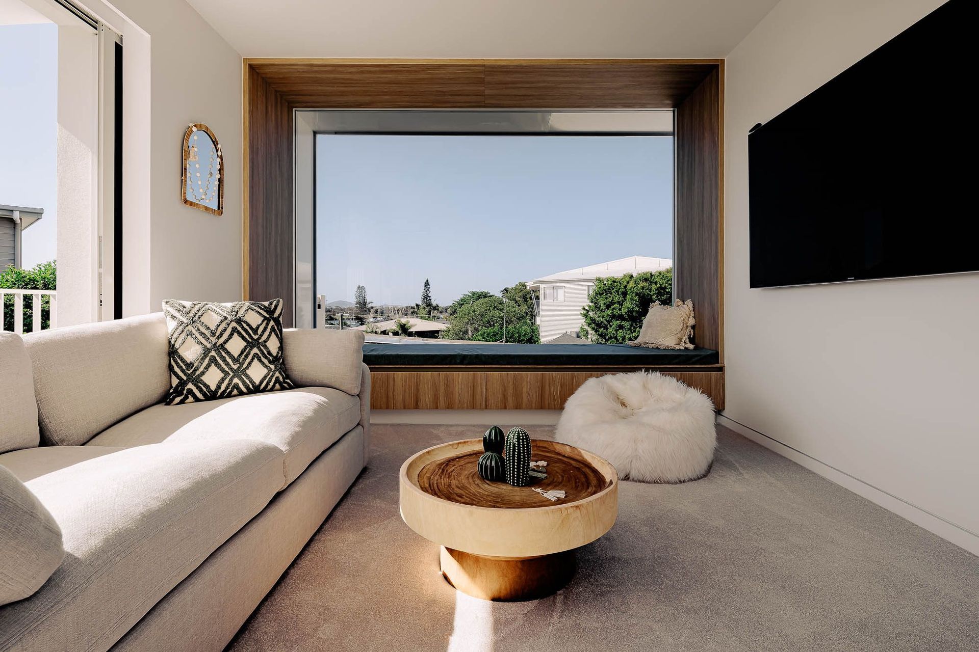 Zaremba Residence - Living Room. Window seat framing views with a timber coffee table.