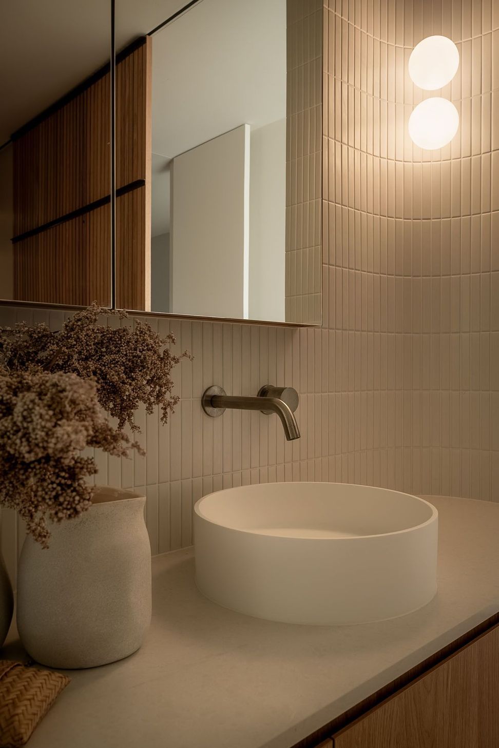 Warrego - Bathroom. Fluted basin and brushed tapware against textured tiles.
