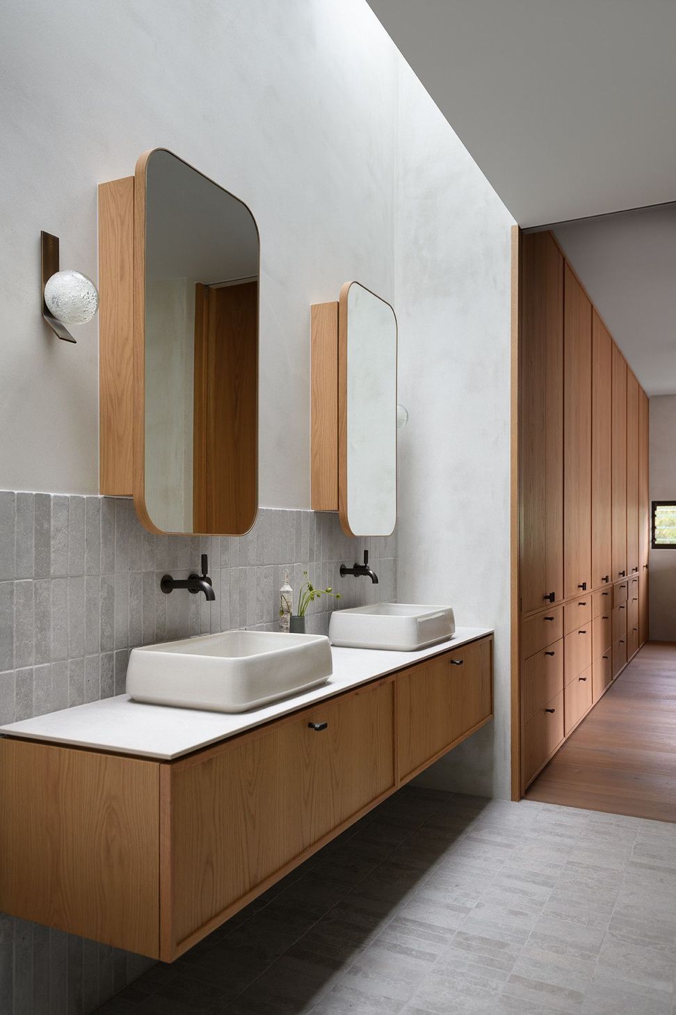 Villa Solare - Bathroom. Double basin timber vanity with rounded mirrors.