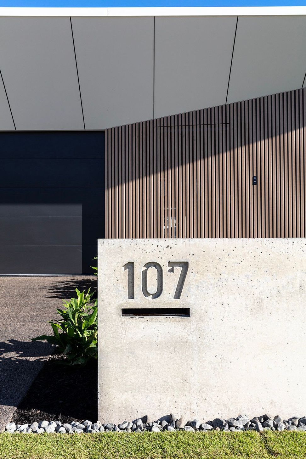 Bells Esplanade - Exterior. House number set into an off-form concrete wall.