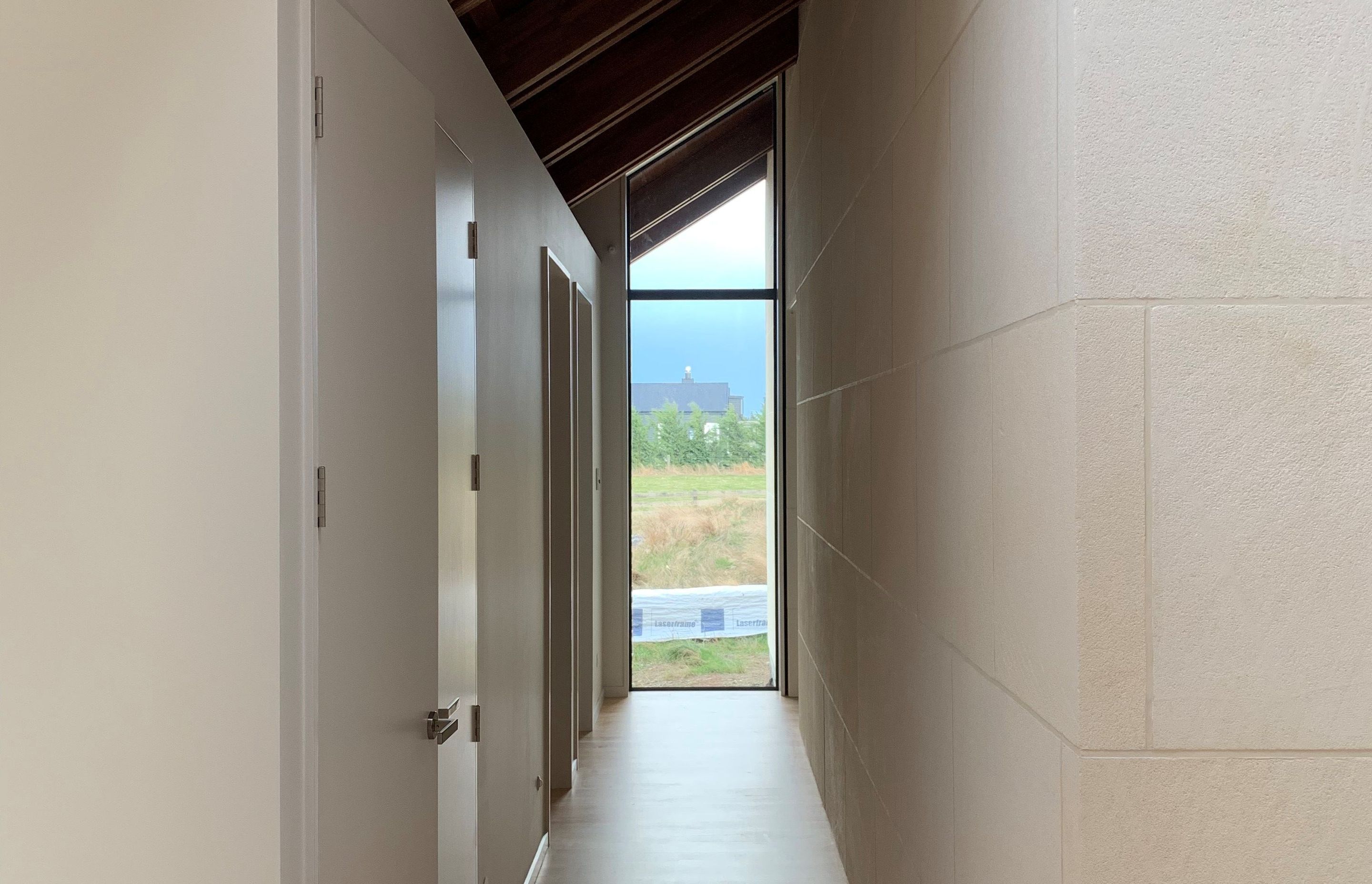 Interior limestone wall. Ōamaru stone sawn faced finish in a custom size.