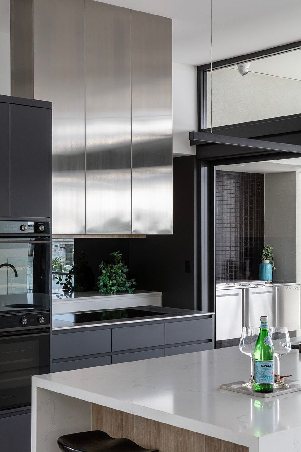 Bells Esplanade - Kitchen. Stainless steel and dark joinery in the scullery.
