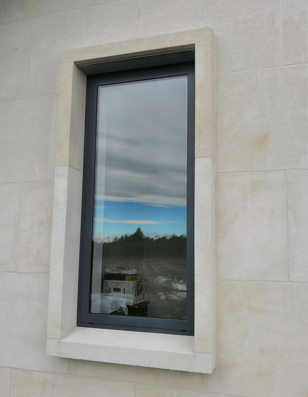 15degree limestone window sill with limestone window jambs and headers. Ōamaru stone.